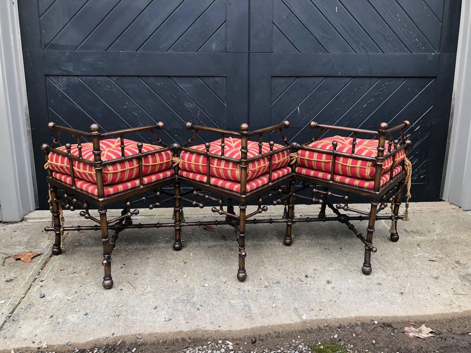 Unique and funky vintage stick and ball bench in bronzed iron. Custom cushions are in red, gold and ivory stripe with gold tassels and trim. 26 inches tall (to top of iron ball). Seat height is 17