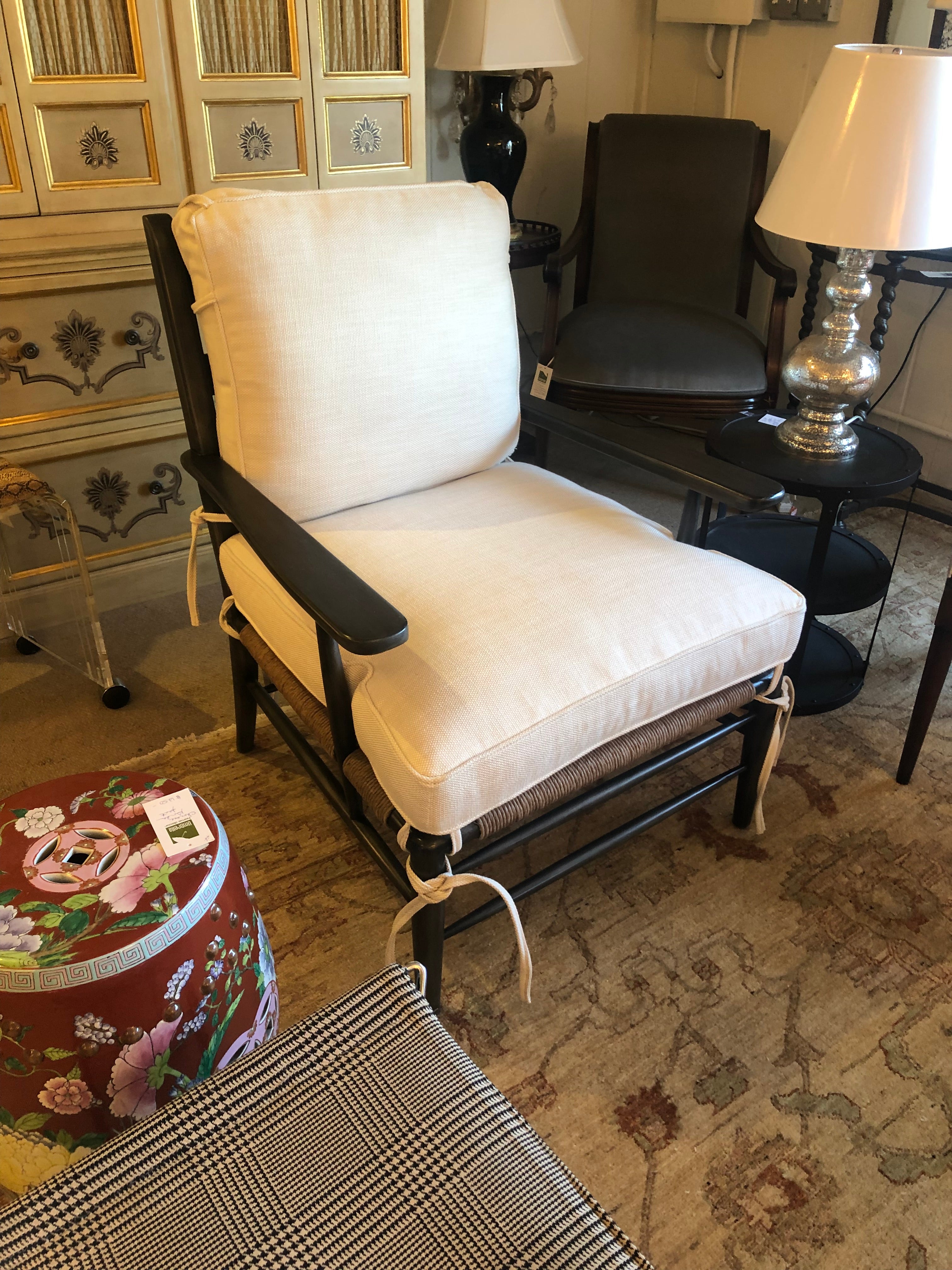 Large comfortable and classic walnut ladder back lounge chair having arms, rush seat, and new white heavy woven, top of the line upholstered cushions. Handsome ties in all cushion corners.
Measures: Arm height 24.