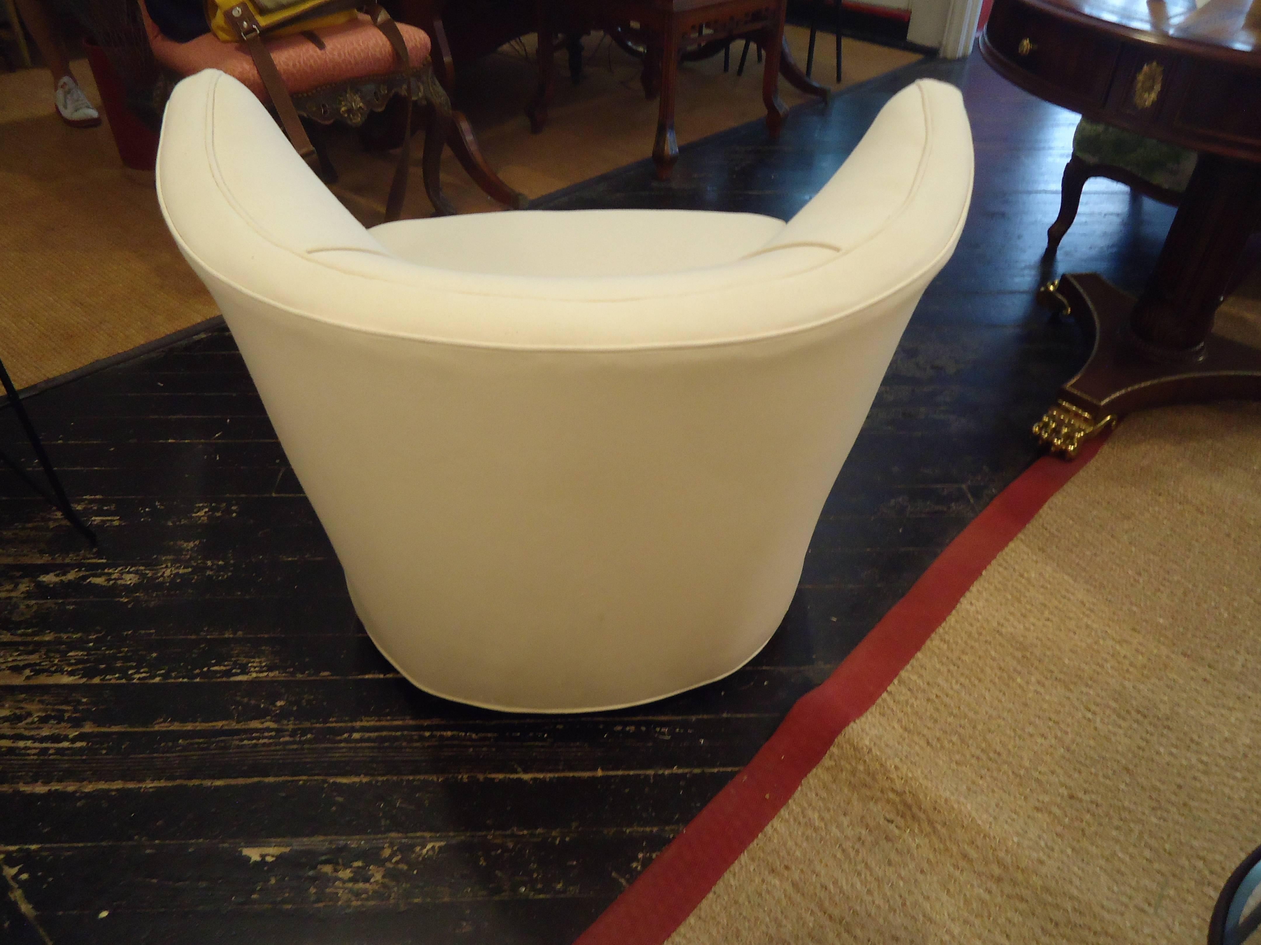 Lovely curved barrel shaped slipper or club chair, newly redone in heavy white duck. On casters. Could be easily converted to a swivel chair.