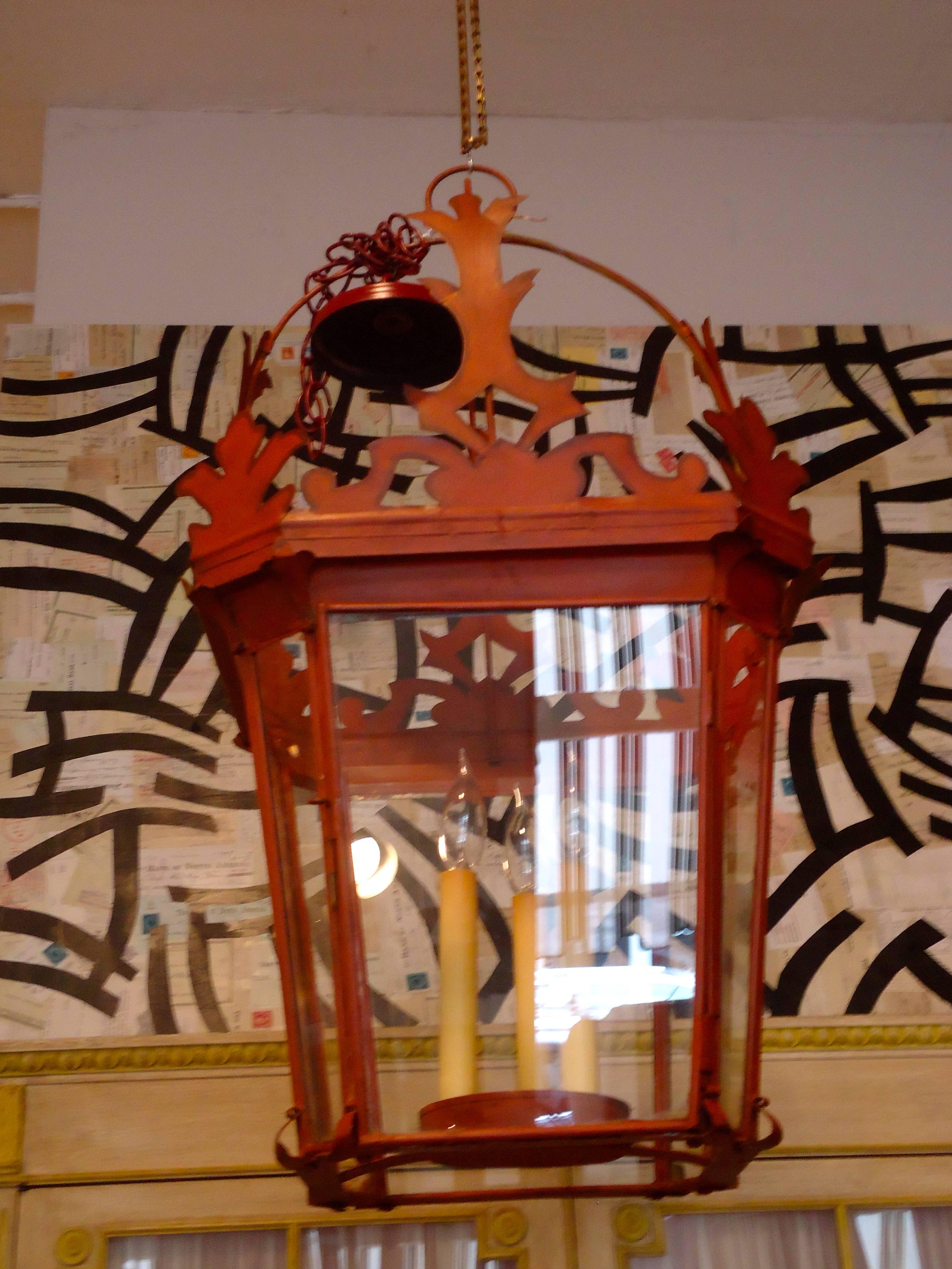 Very unusual red tole metal lantern with three candle lights inside.