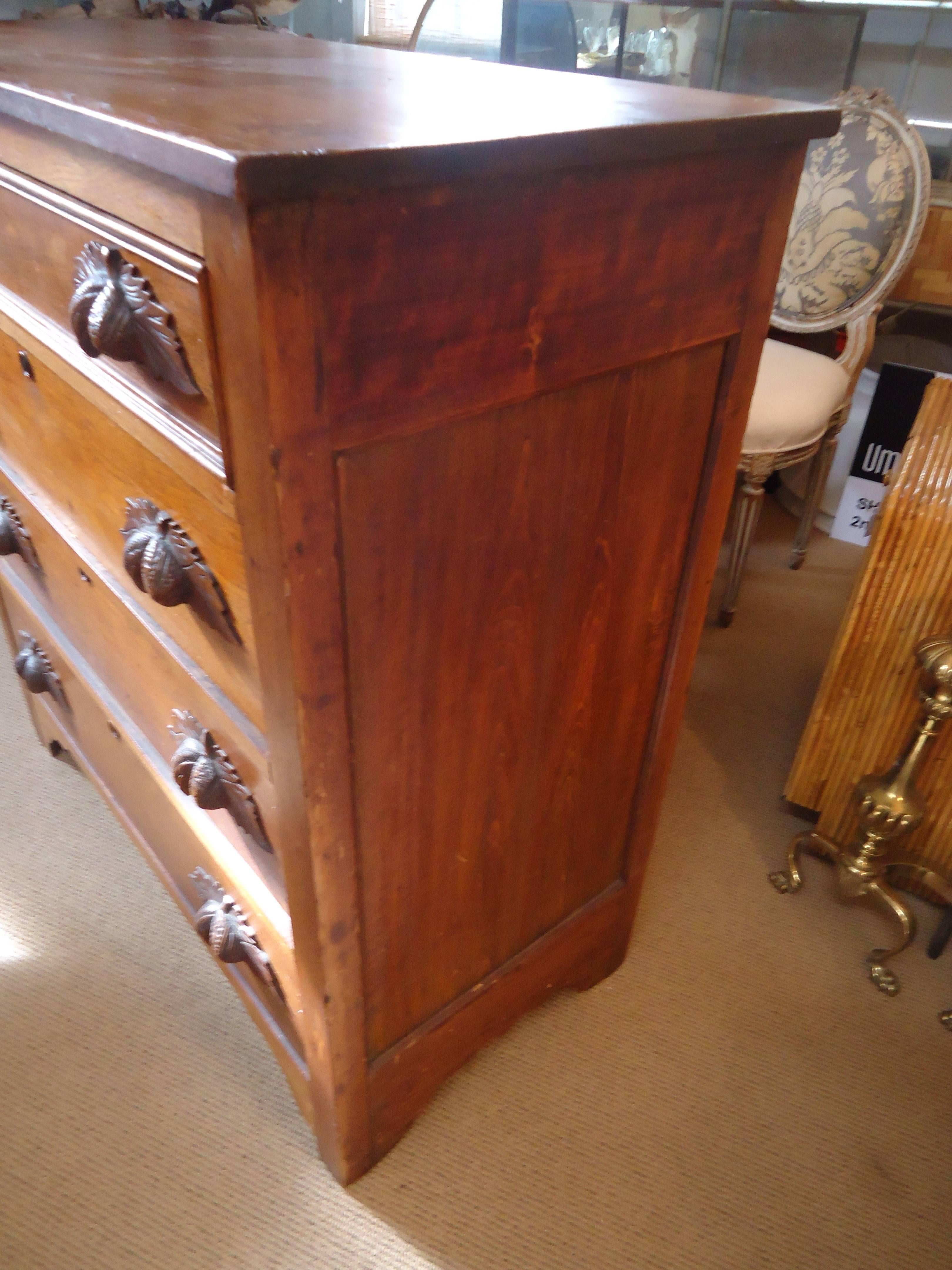 Great medium sized walnut dresser with four drawers and wonderful carved wood handles in a leaf and nut motif.