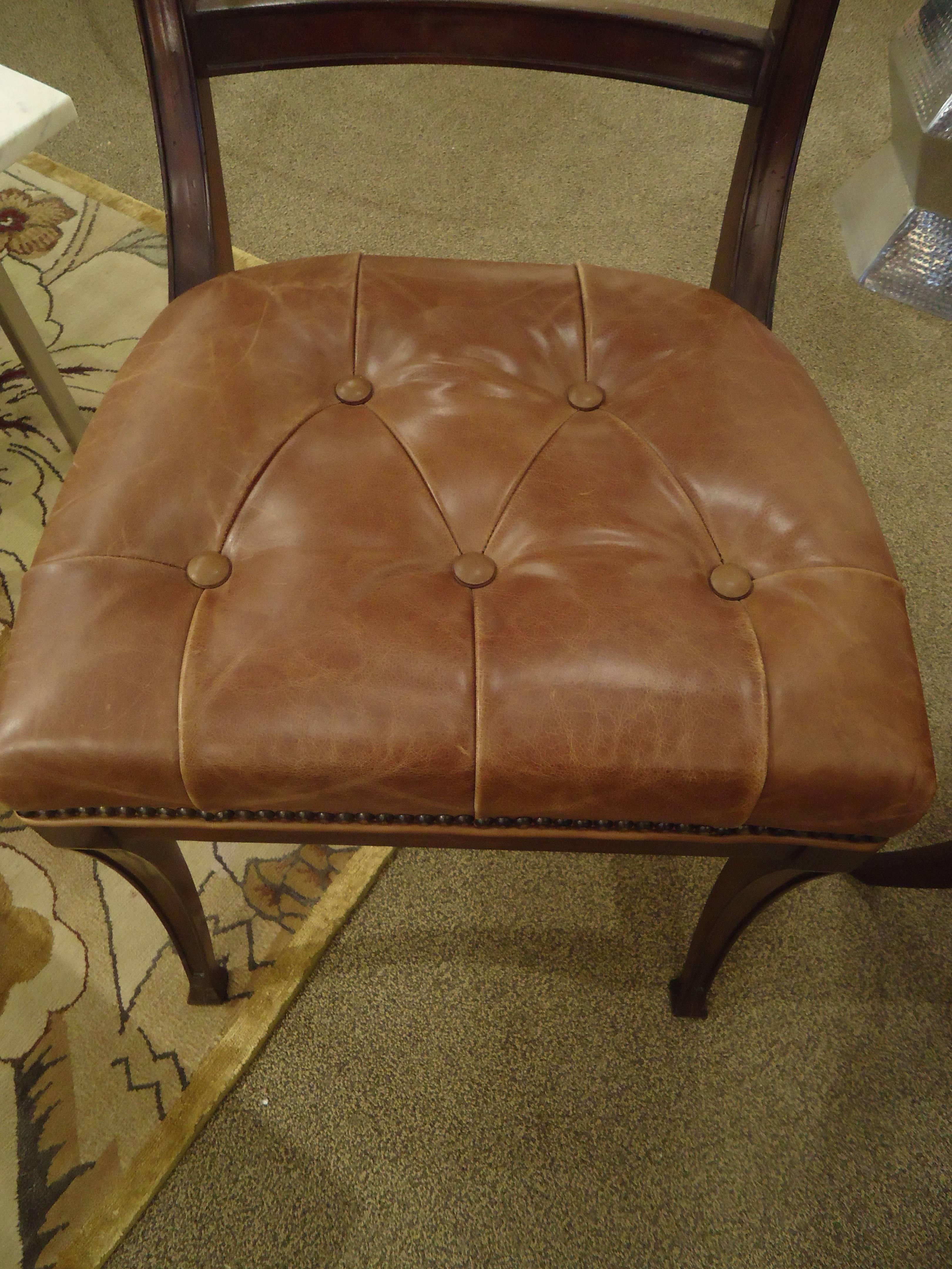 Four beautifully designed elegant side chairs/dining chairs with distressed leather button tufted seats and brass nailhead detailing and rich dark mahogany frames. Henredon label underside.
Measures: Seat width 20