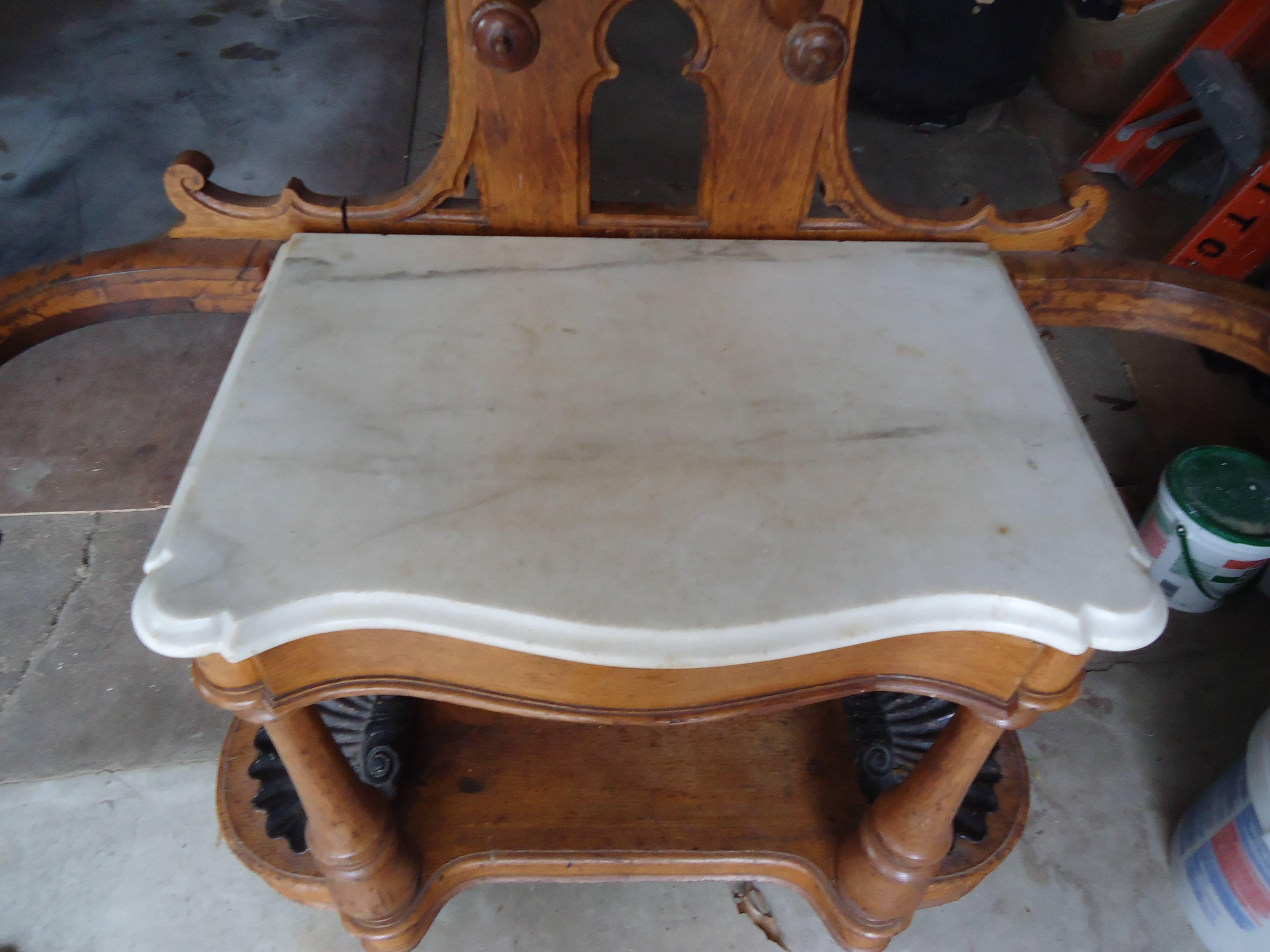 Beautiful Gothic design and functional too, having a marble surface and single drawer, with mirror and multiple places to hang coats, hats and the like.
On the bottom are two ebonized iron shell shaped dishes -- great for keys or extra change.  To