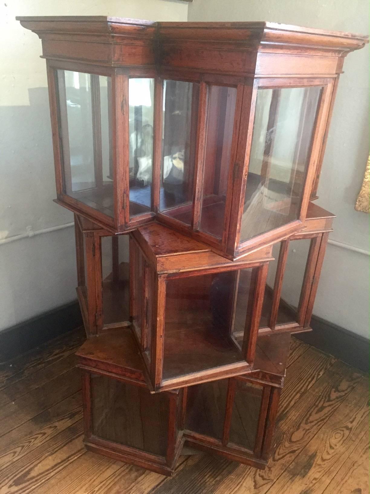 Fabulous mahogany and glass antique curio cabinet, angular and round, that can be turned 360 degrees to show books and objet d'art inside it's numerous cubicles.