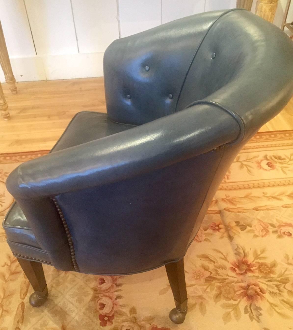 English tub chair on castors with brass nailheads, upholstered in a soft steel blue leather. A great desk chair!

Measures: 18