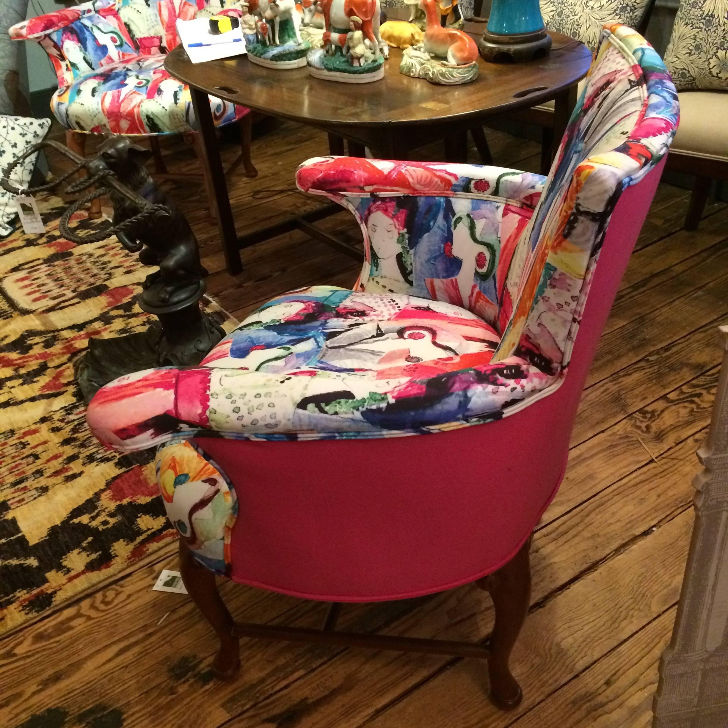 Sophisticated Oly armchairs in a compact size with eye-catching cotton and quill hand screened upholstery having fashionable lady's faces on the front and hot pink solid fabric on the back. Measure: Seat height 18.5.