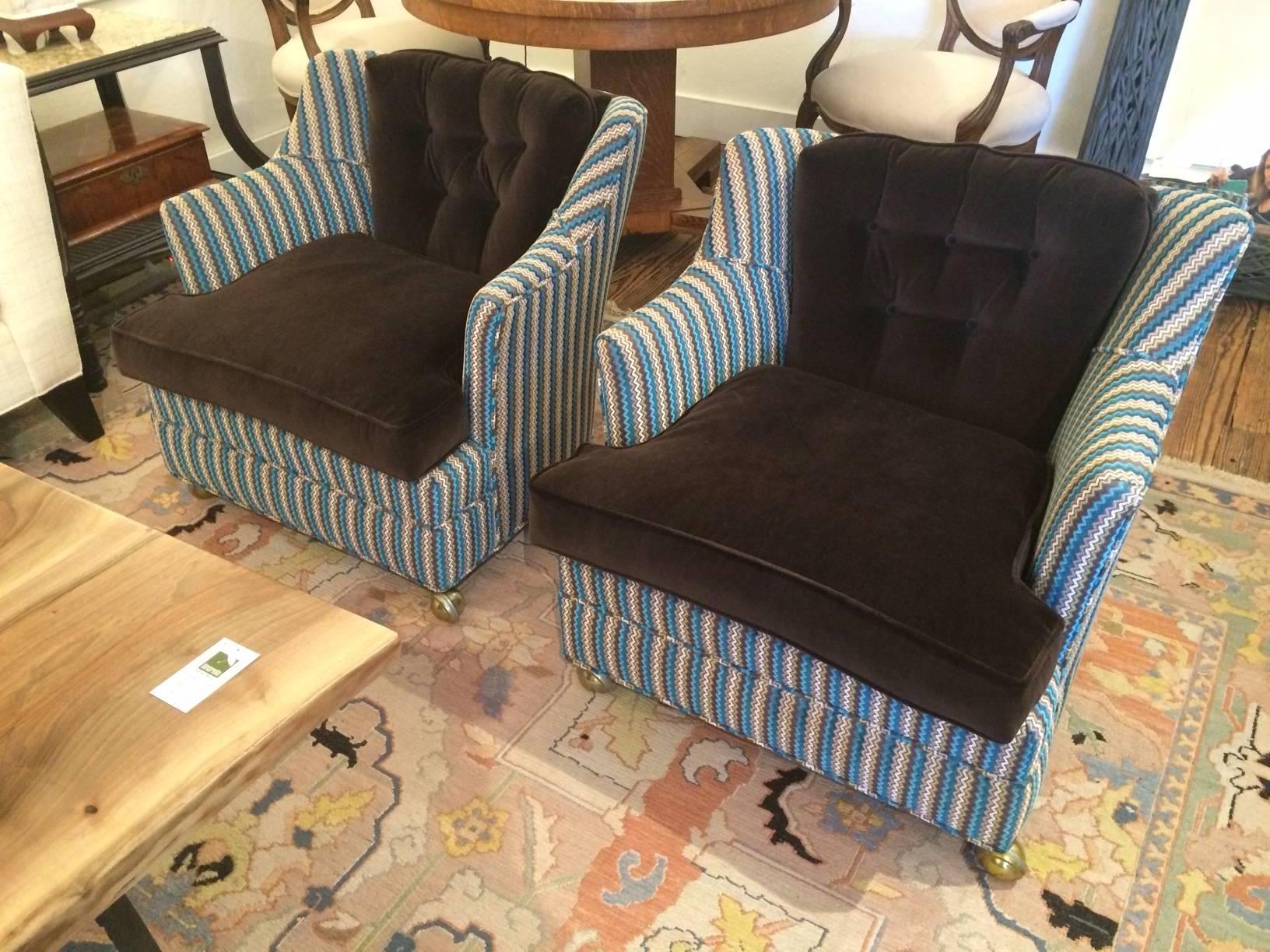 Darling low slung upholstered club chairs, originally from the 1960s, contemporized with an imaginative mix of top of the line fabrics. Reupholstered about 3 years ago. Seats and backs are chocolately brown velvet, the rest is a modernized flame