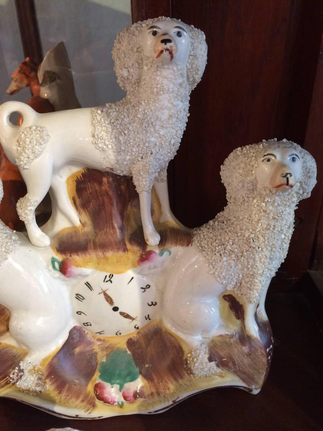 The largest in the grouping is a faux clock with three dogs, there's a bookend pair of sitting pooches, and two that are partially reclining. 
Two seated dogs: 3