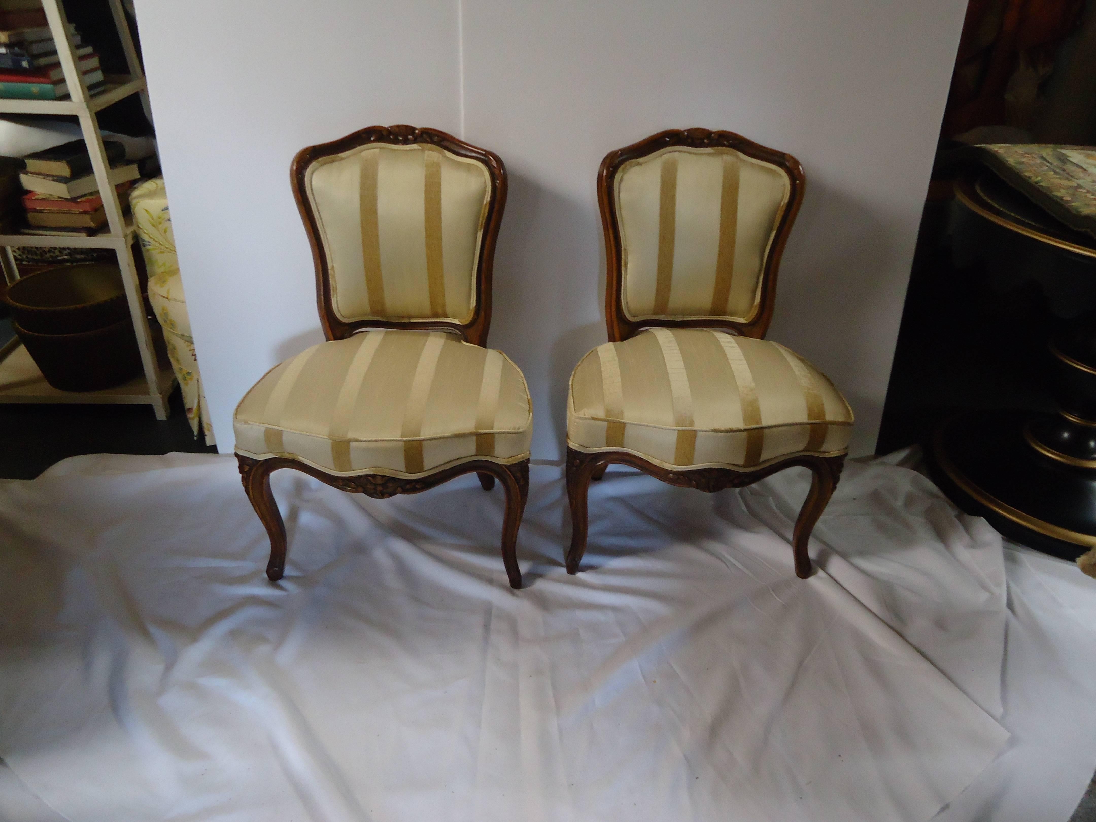 Two movie star gorgeous slipper chairs with carved walnut frames, upholstered in light sand raw silk and velvet striped fabric. Cabriole legs and pretty cartouches at the top.