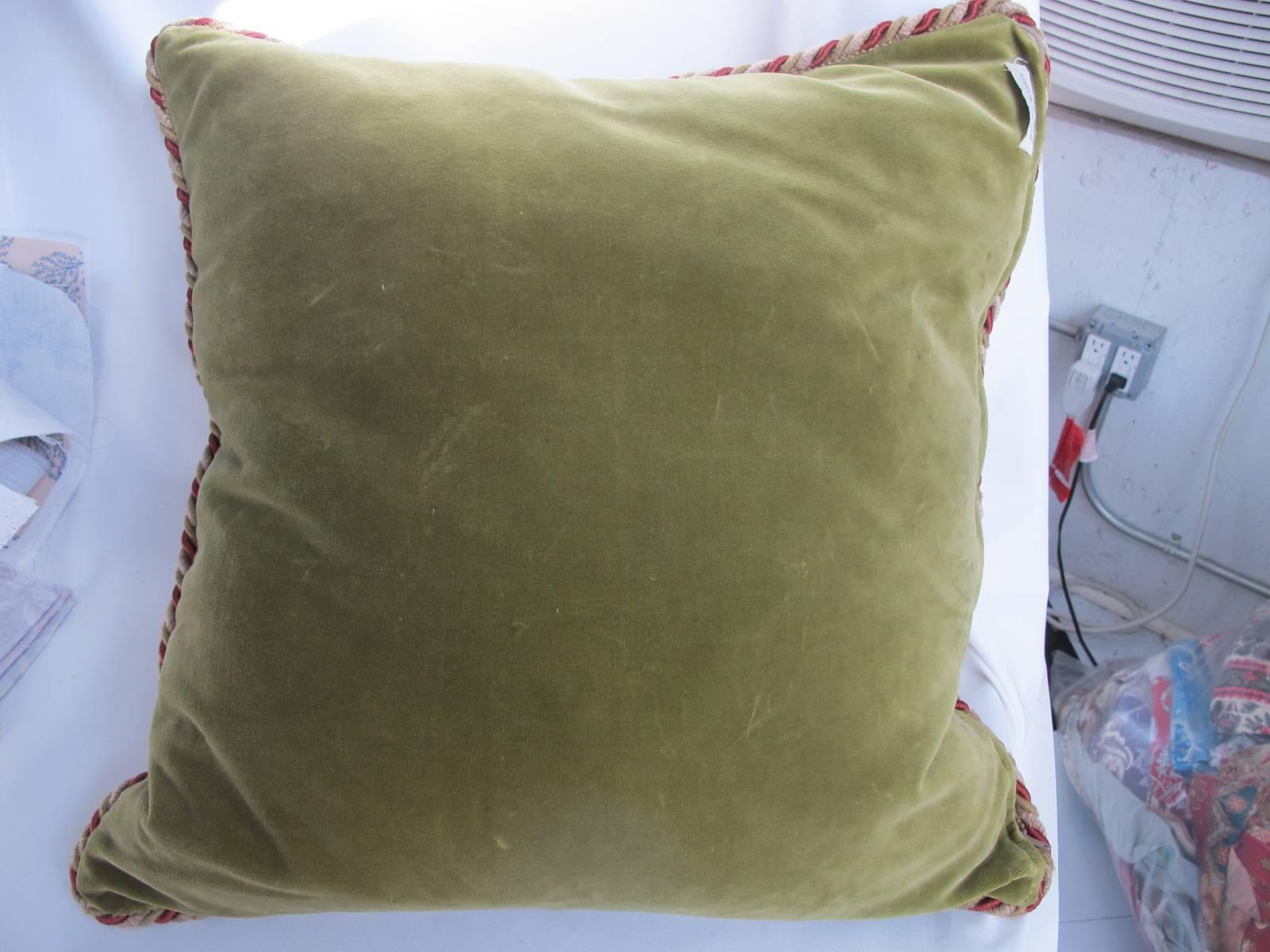 A newly made pillow from a circa 1920s hand-stitched crewel work panel, backed with a coordinating olive green velvet, includes a down insert, hidden zipper closure, 22