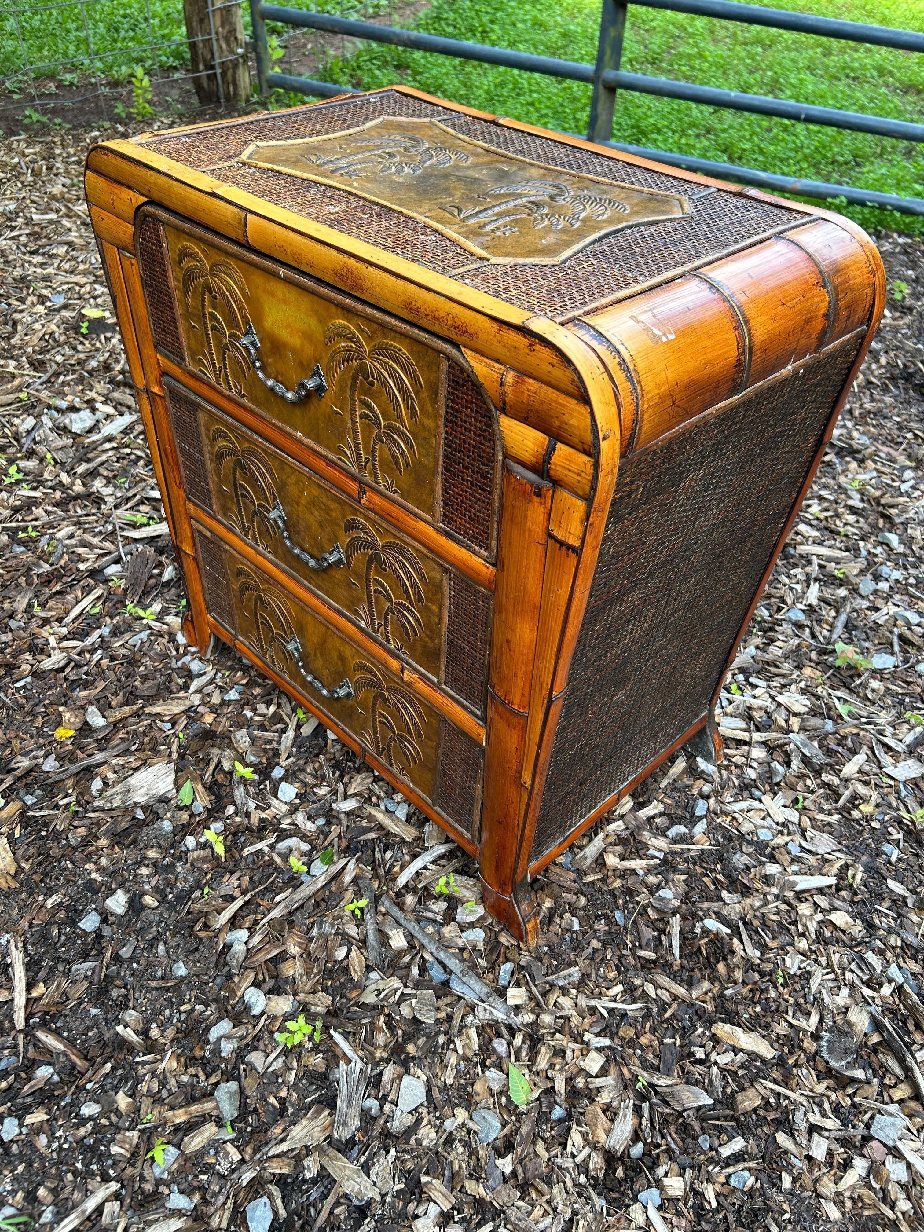 Very unusual stylish small rattan and bamboo chest of drawers having embossed decoration on the top and 3 drawers with palm trees.
Would be great in a bathroom or as a night stand.