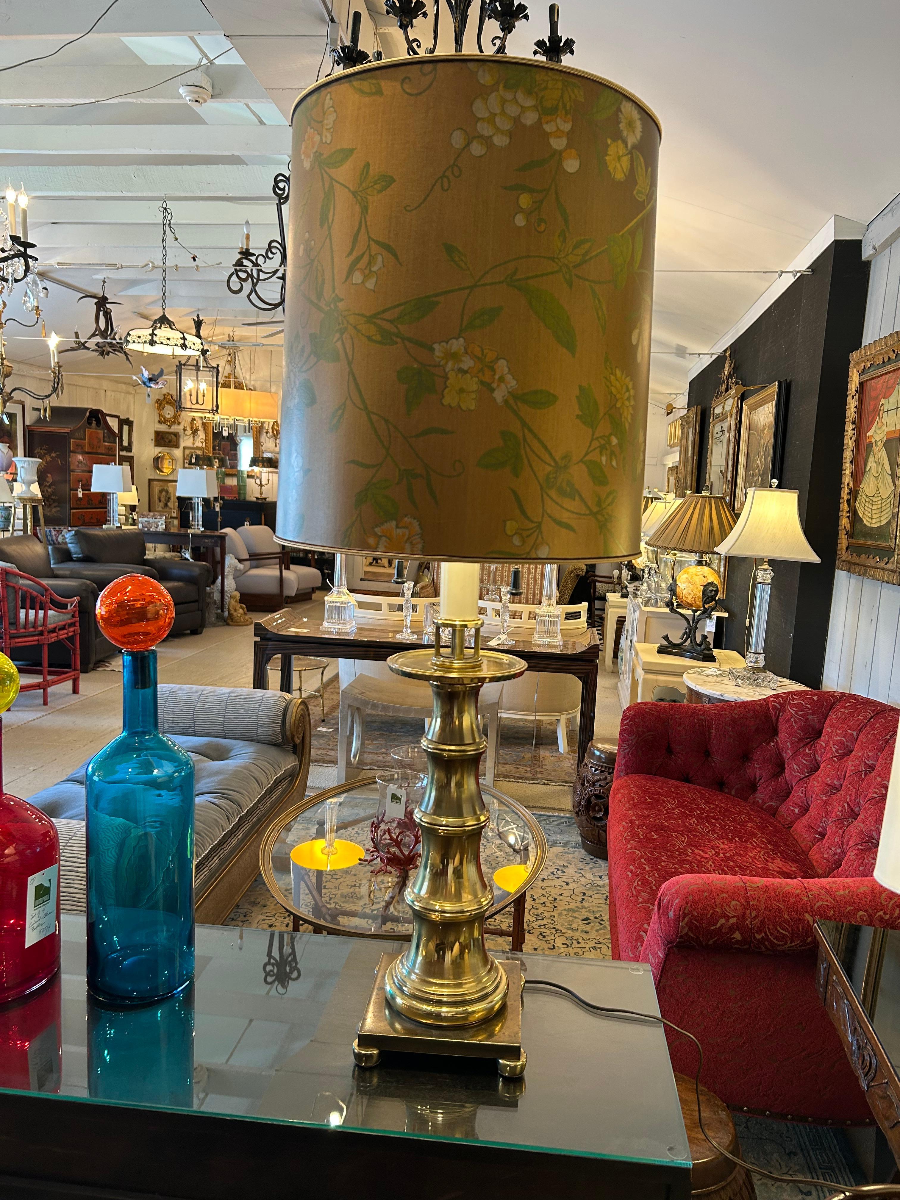 Impressive tall large table lamp by Stiffel having bamboo inspired columnar brass lamp on 7.5” square base with round feet.  Shade is a show stealer that looks hand painted with gold background and floral motif.

Patty