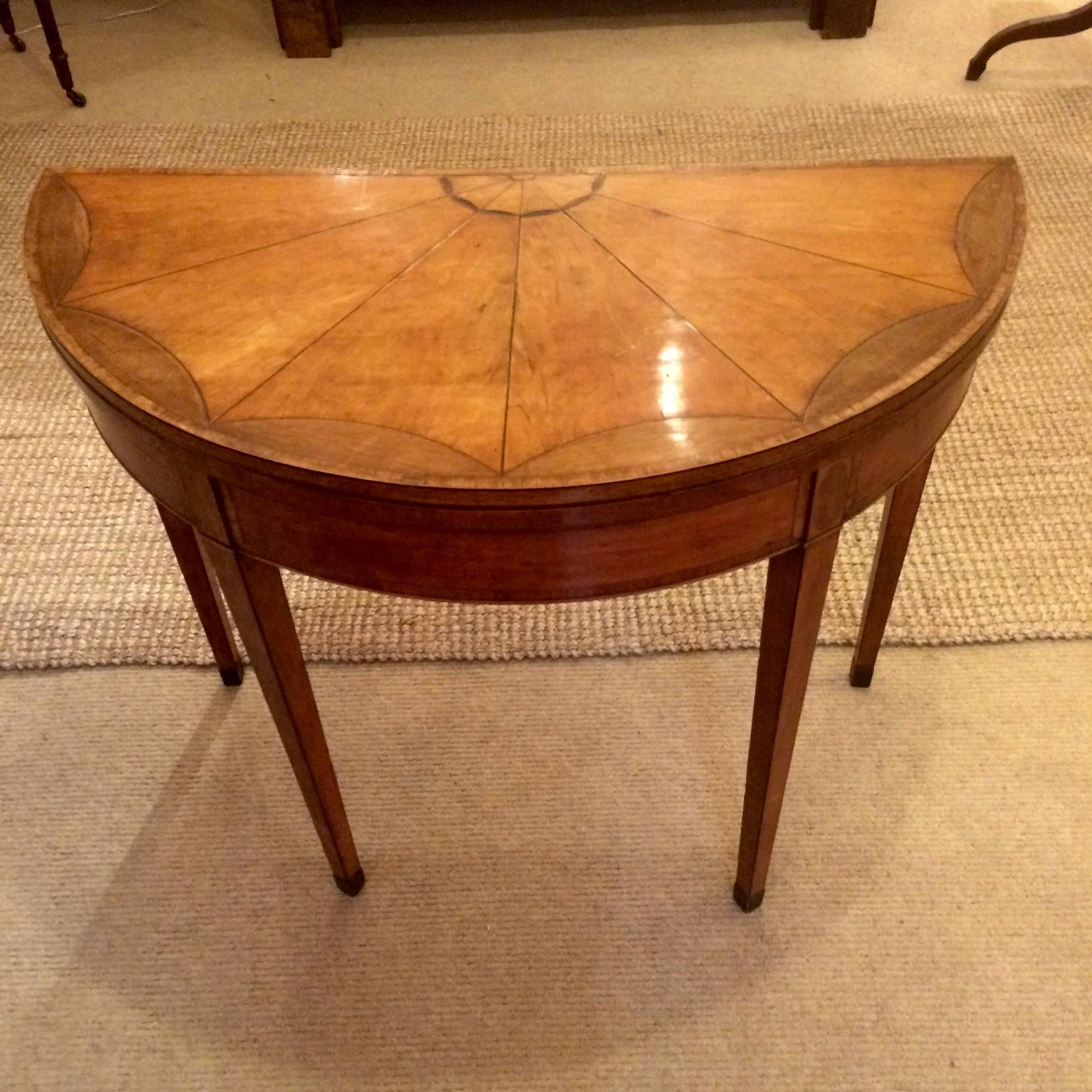 Rare gorgeous demilune game table with honey colored mahogany and satinwood inlay and a wonderful starburst design on top; opens to reveal a pristine camel colored felt top and becomes a round table 36