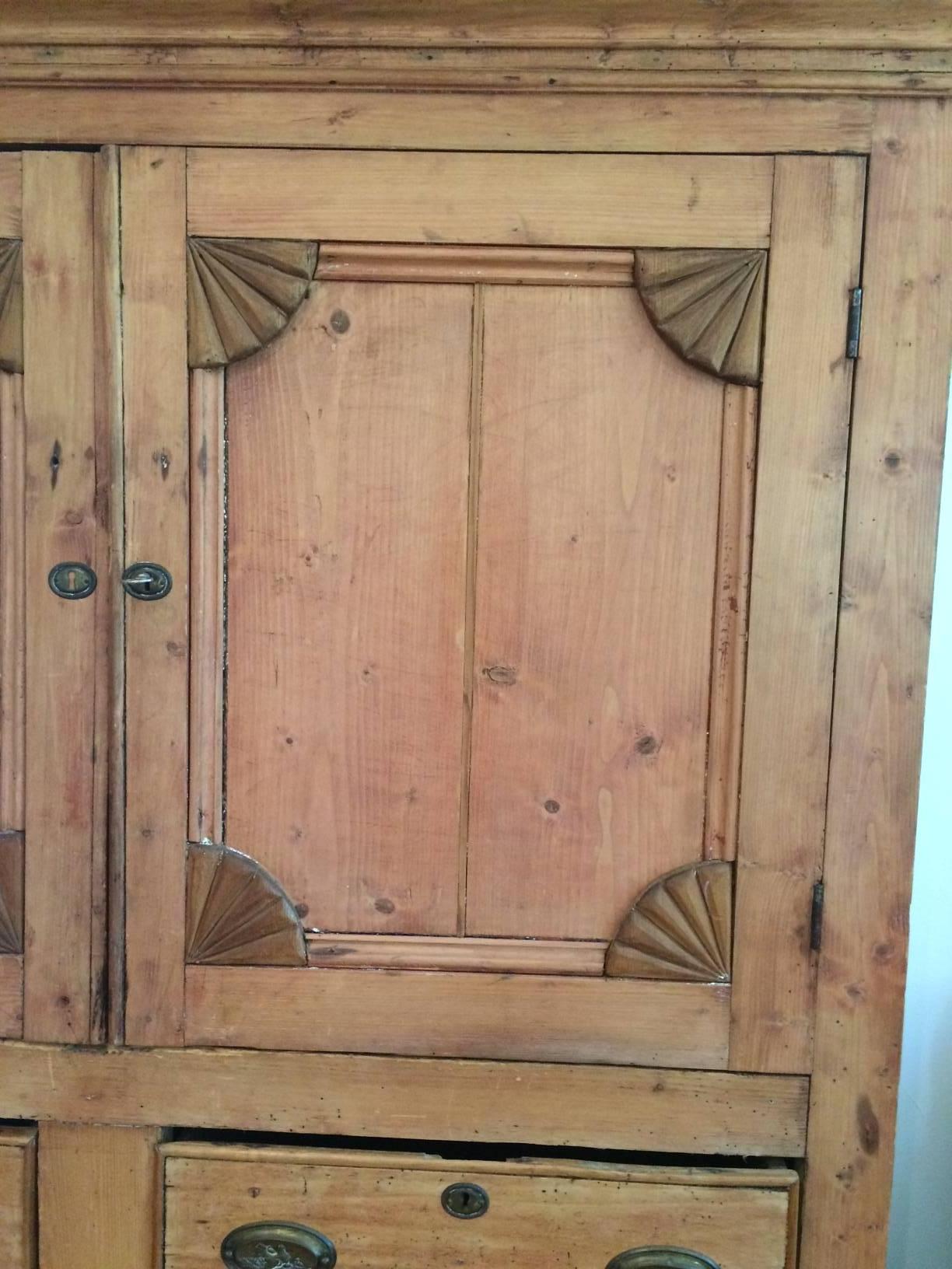Old authentic rustic charm found in a large pine linen press oozing with character, having two panel doors on the top section, two drawers in the middle with 