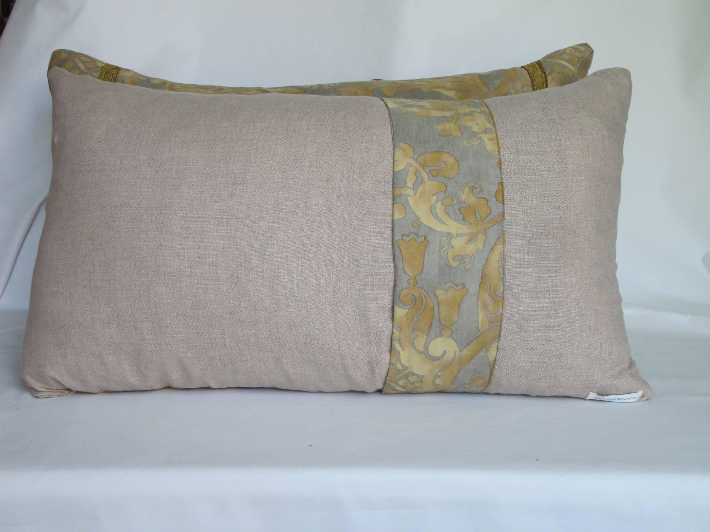 A pair of pillows made from a, circa 1950s Fortuny fabric in muted shades of taupe and gold, backed with natural Belgian linen and embellished with antique metallic trim, with an envelope closure, down inserts included.
       
     
    