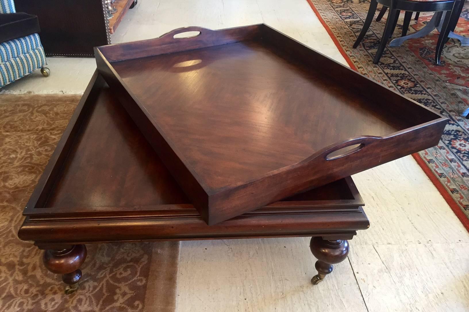 Large elegant mahogany coffee table with removable butler's tray top and chunky ball legs on brass casters, by Restoration Hardware.
16 1/2