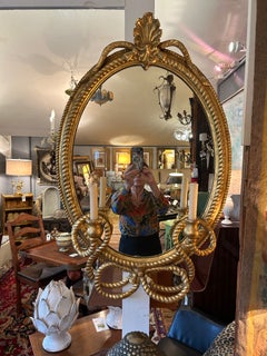 Magnifique miroir ovale antique italien en bois doré