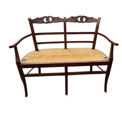 Banqueta doble clásica de estilo vintage en madera de nogal con asiento de junco