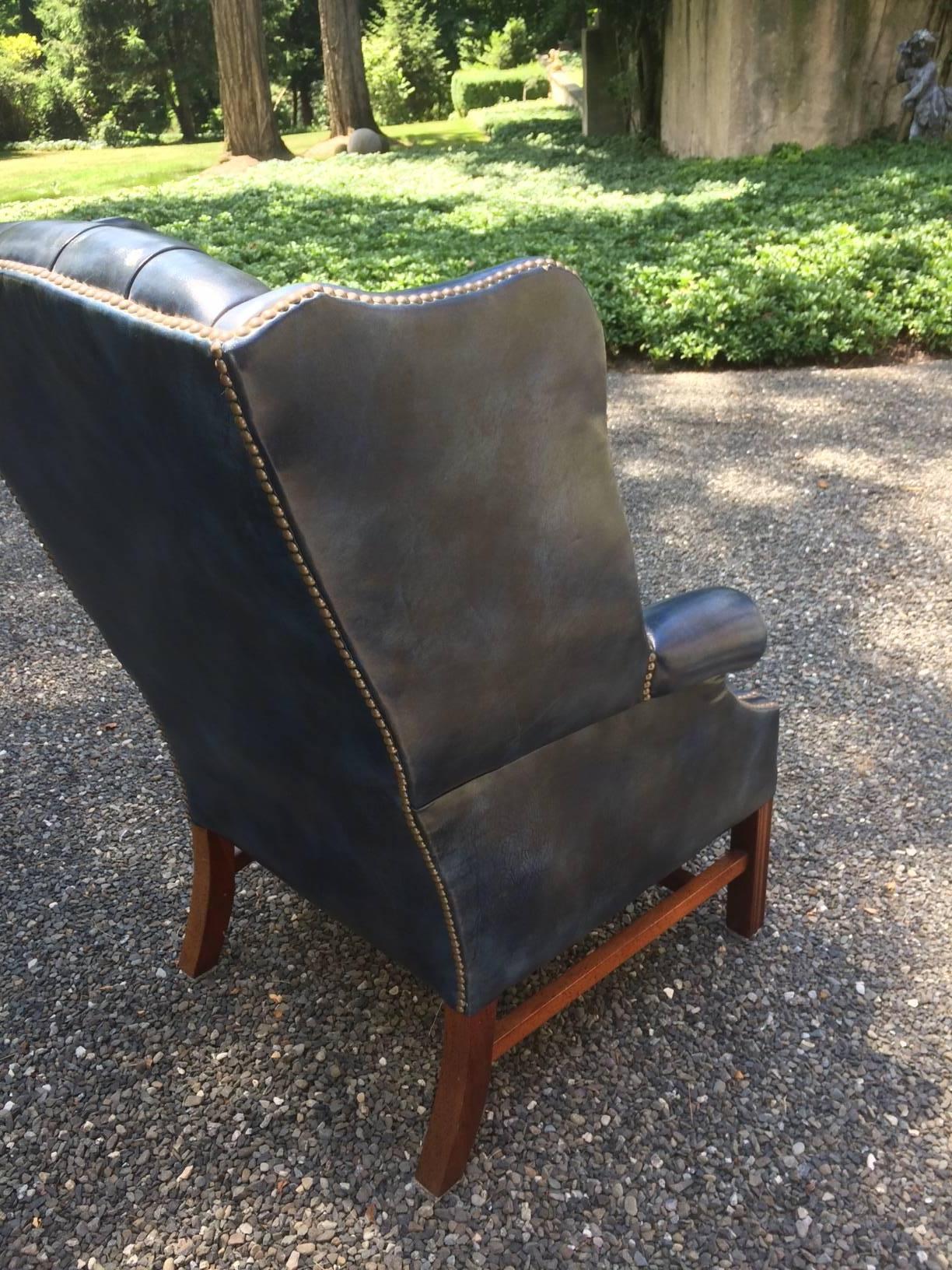 Fabulous color ink/navy blue leather wing chair with Chippendale style legs.
Measures: 45