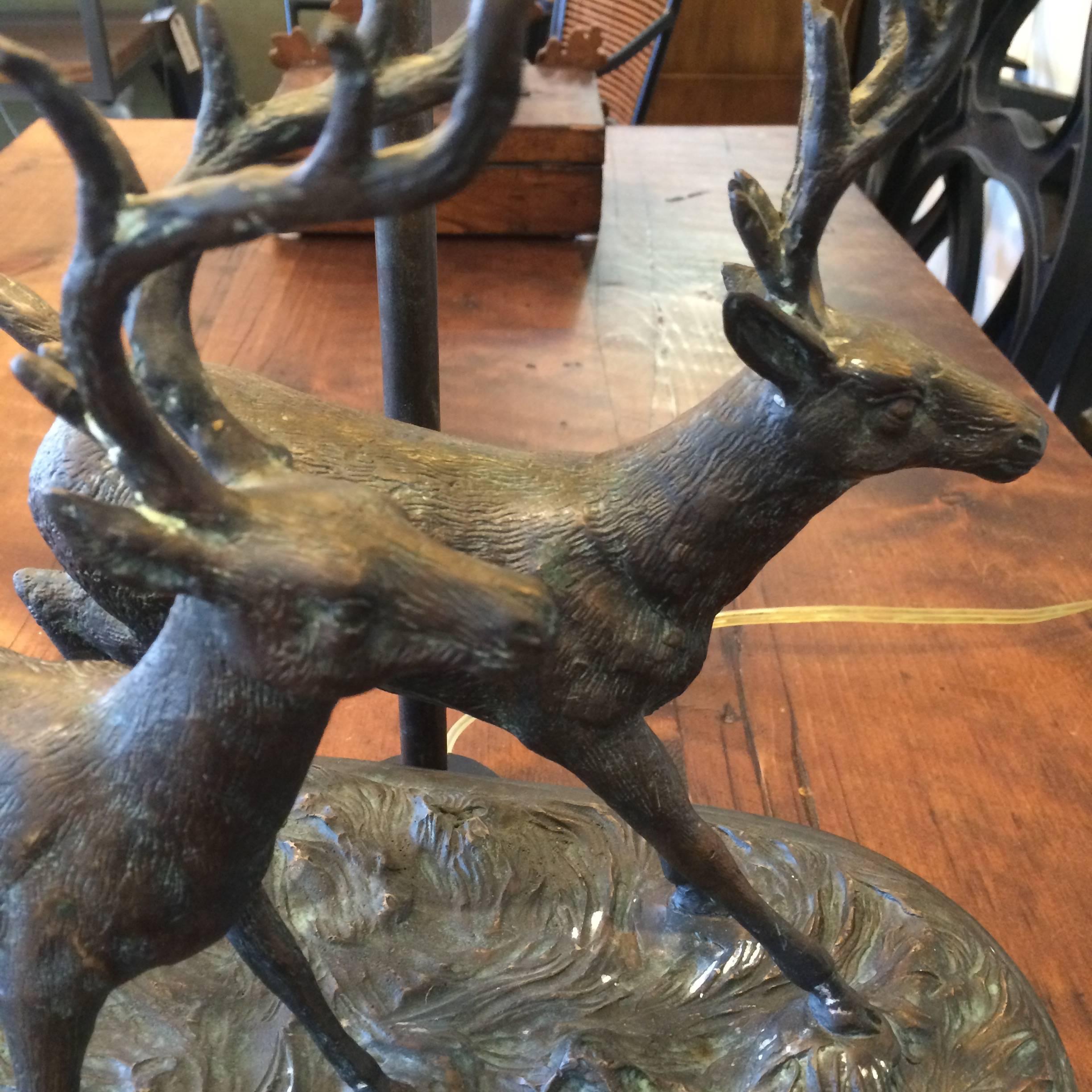 Gorgeous handcrafted bronze and black marble lamp having two handsome deer running in a rugged landscape. The shade is a rich leather with beautiful brass finial on top. Maitland Smith label underneath. Shade is 20 W 10 D 10.5 H.
Base measures 16.5