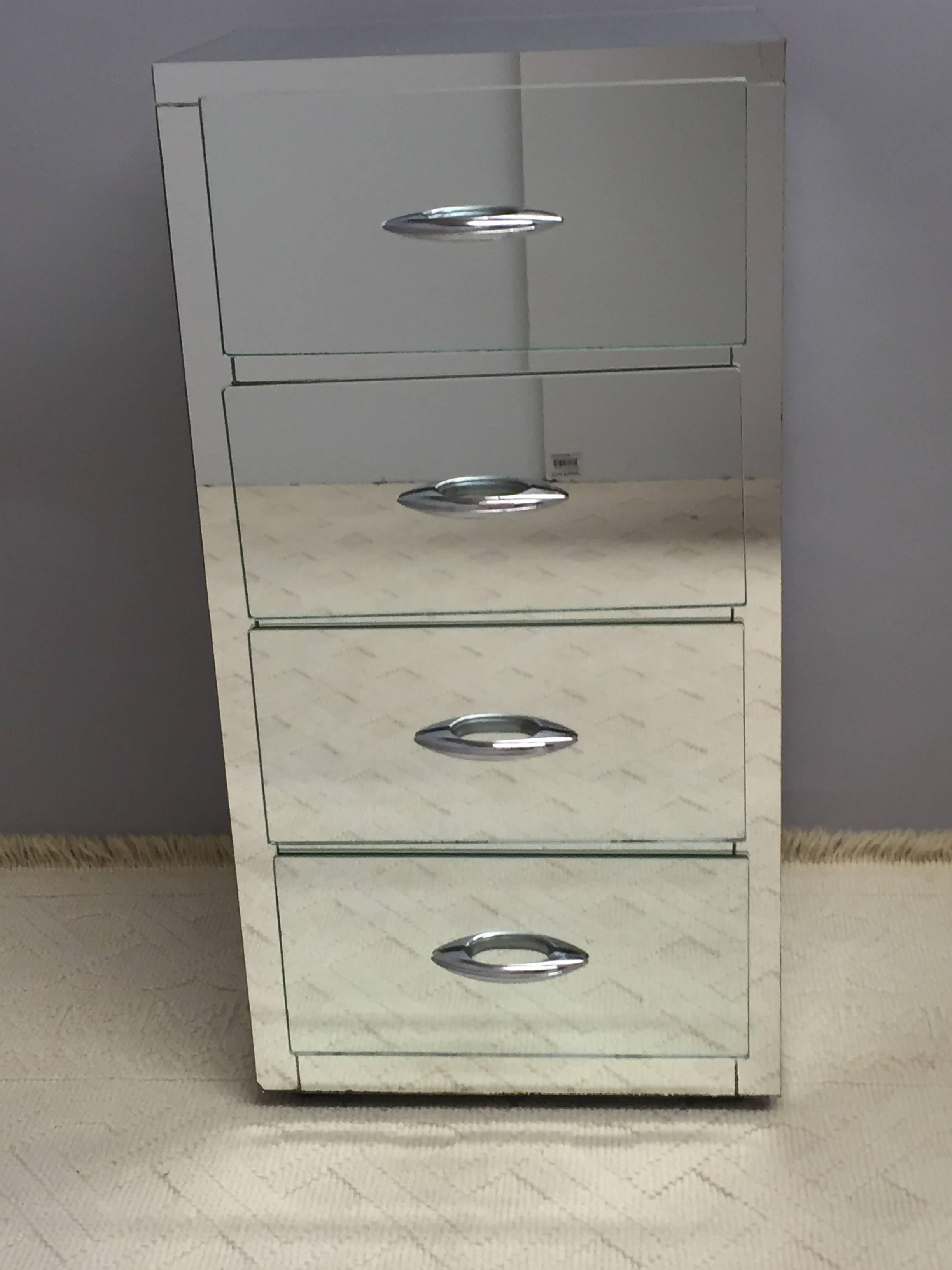 Mirrored narrow chest having four drawers and chrome covered brass hardware. Associated piece with a vanity also on our storefront. Mirrored on three sides; back is plain brown.

RR
 