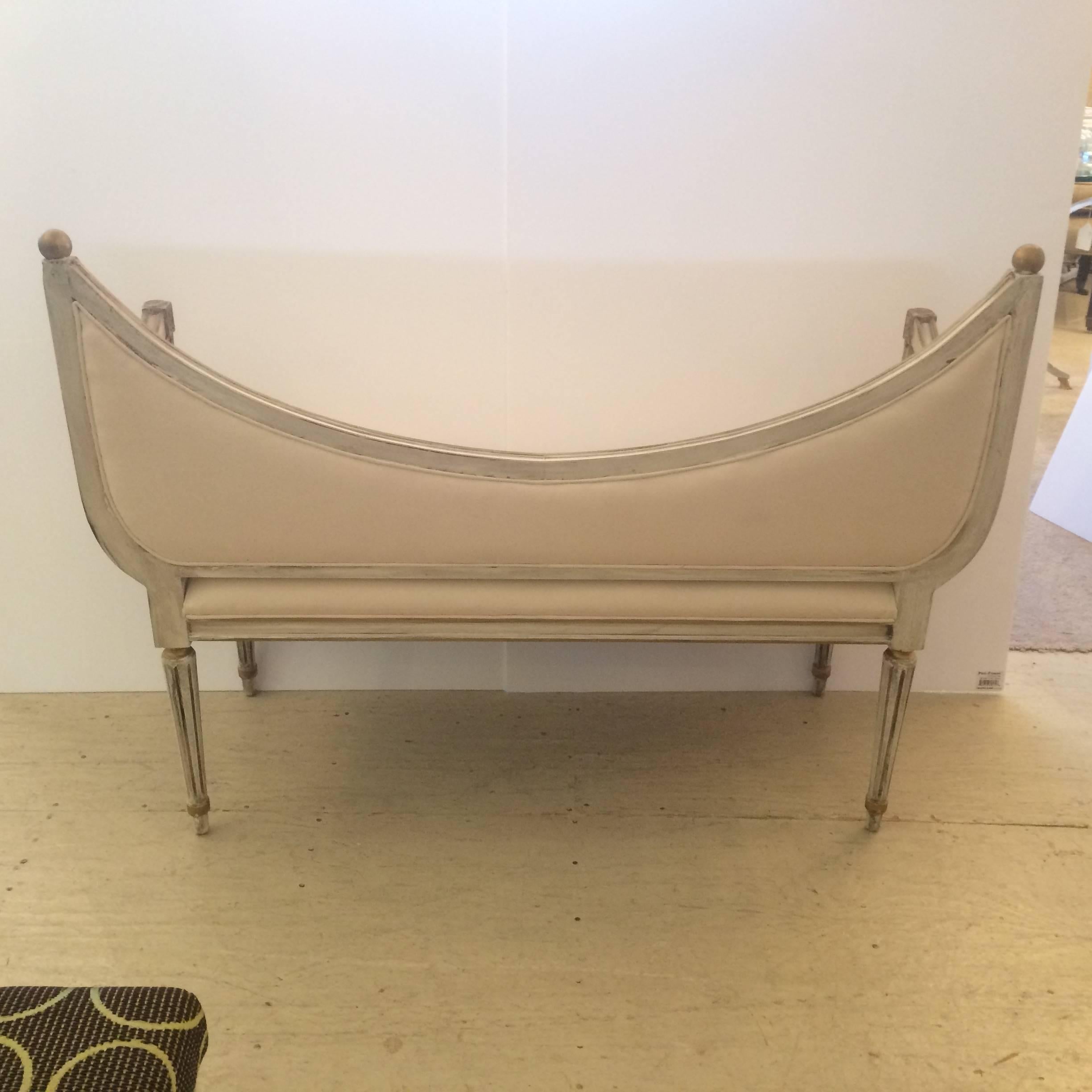 Dreamy scoop back settee bench with original grey Gustavian grey wood, reeded legs and wonderfully shaped arms, gilt ball finials and detailing, newly upholstered in white duck.
Measures:
Seat height 17