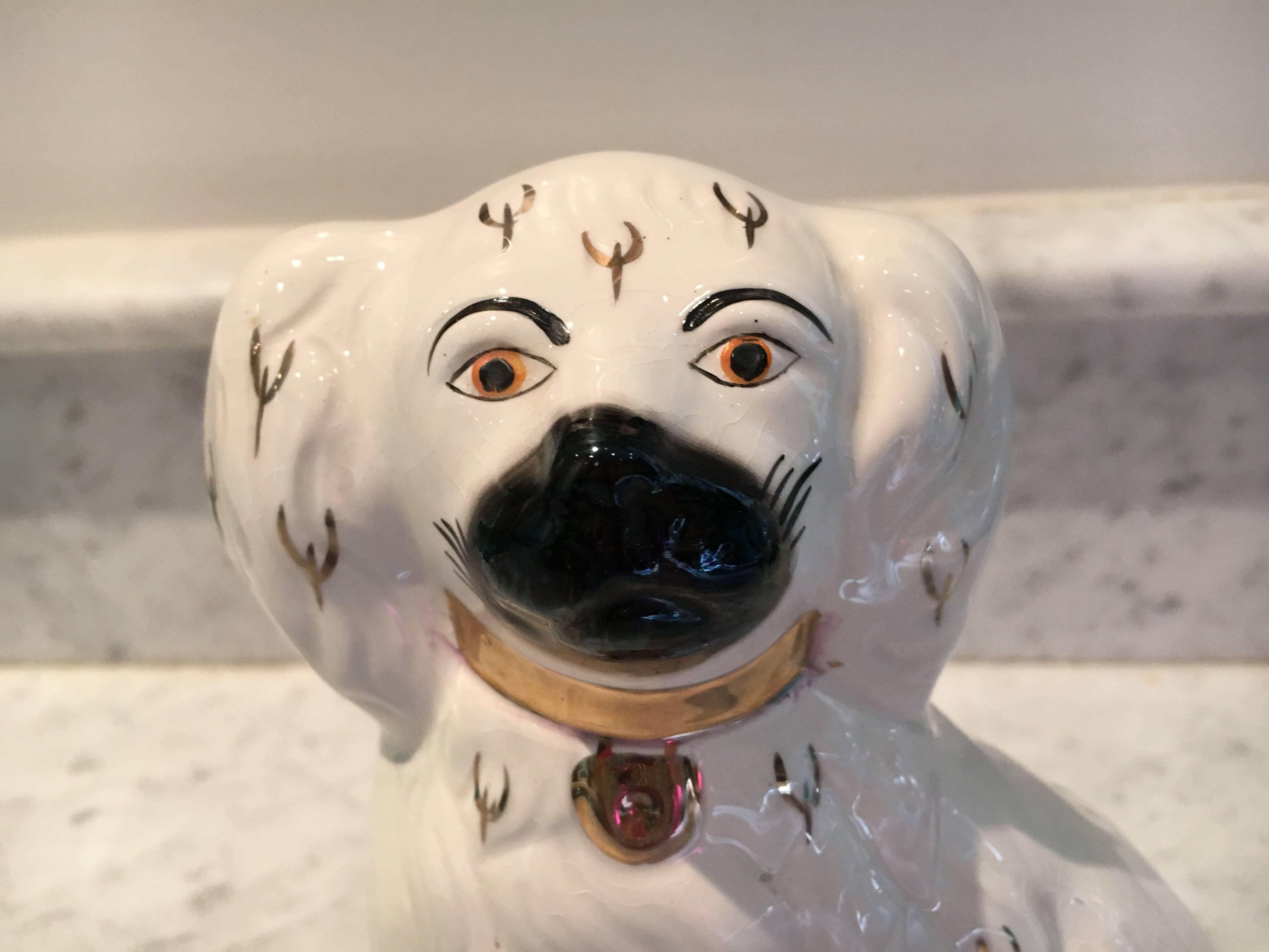 Antique white Staffordshire dog with black muzzle and gold accents. Measures marked 