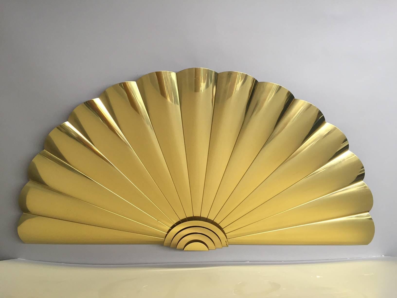 Large sculptural brass sunburst wall sculpture with undulating fan like ripples, signed and dated by world renown artist Curtis Jere. Two semi circular pieces can be hung separately or together to form a perfect circle with two raised concentric