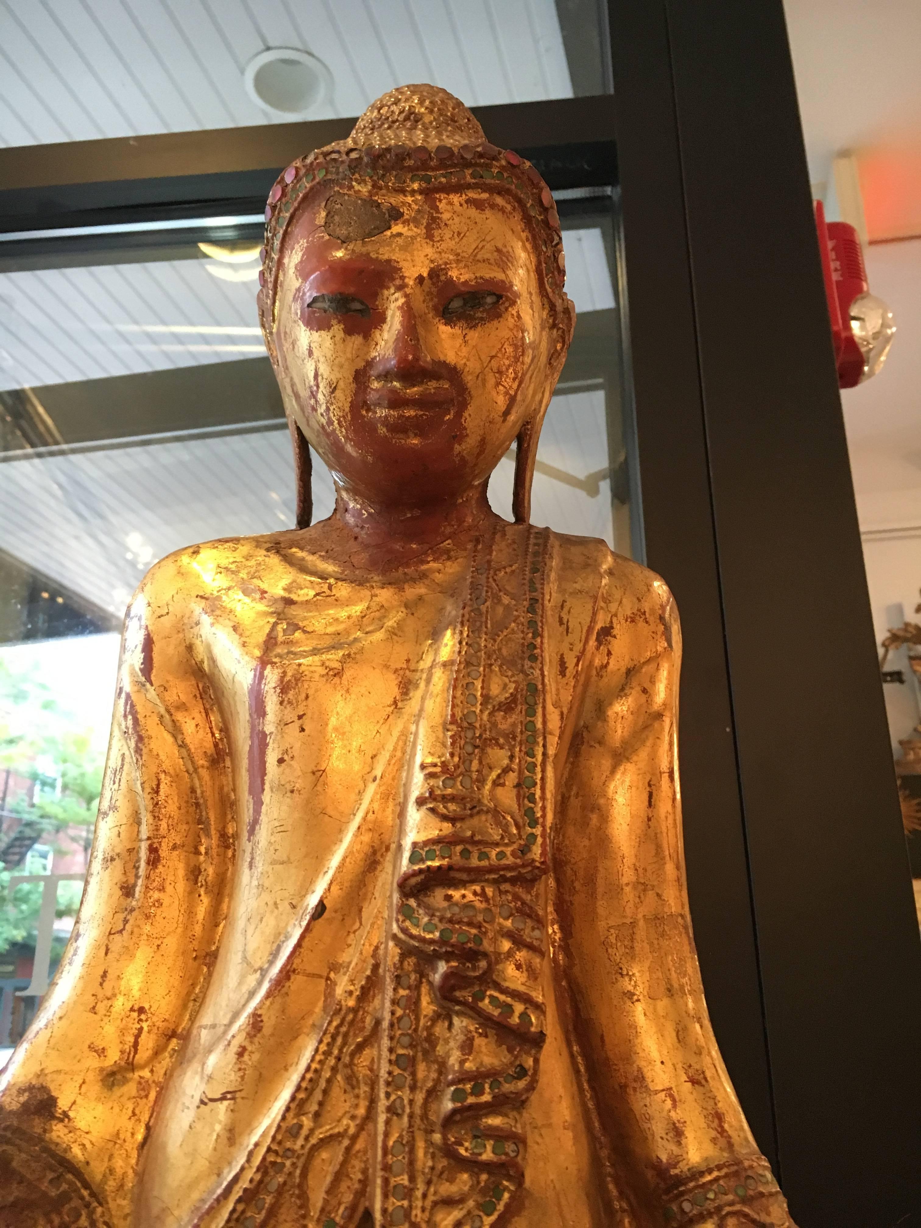 Fabulous 19th century carved Buddha, gilt decoration and inlaid with jewels (some missing). Outstanding patina. Comes with appraiser's certificate of authenticity. Measures 35 1/4