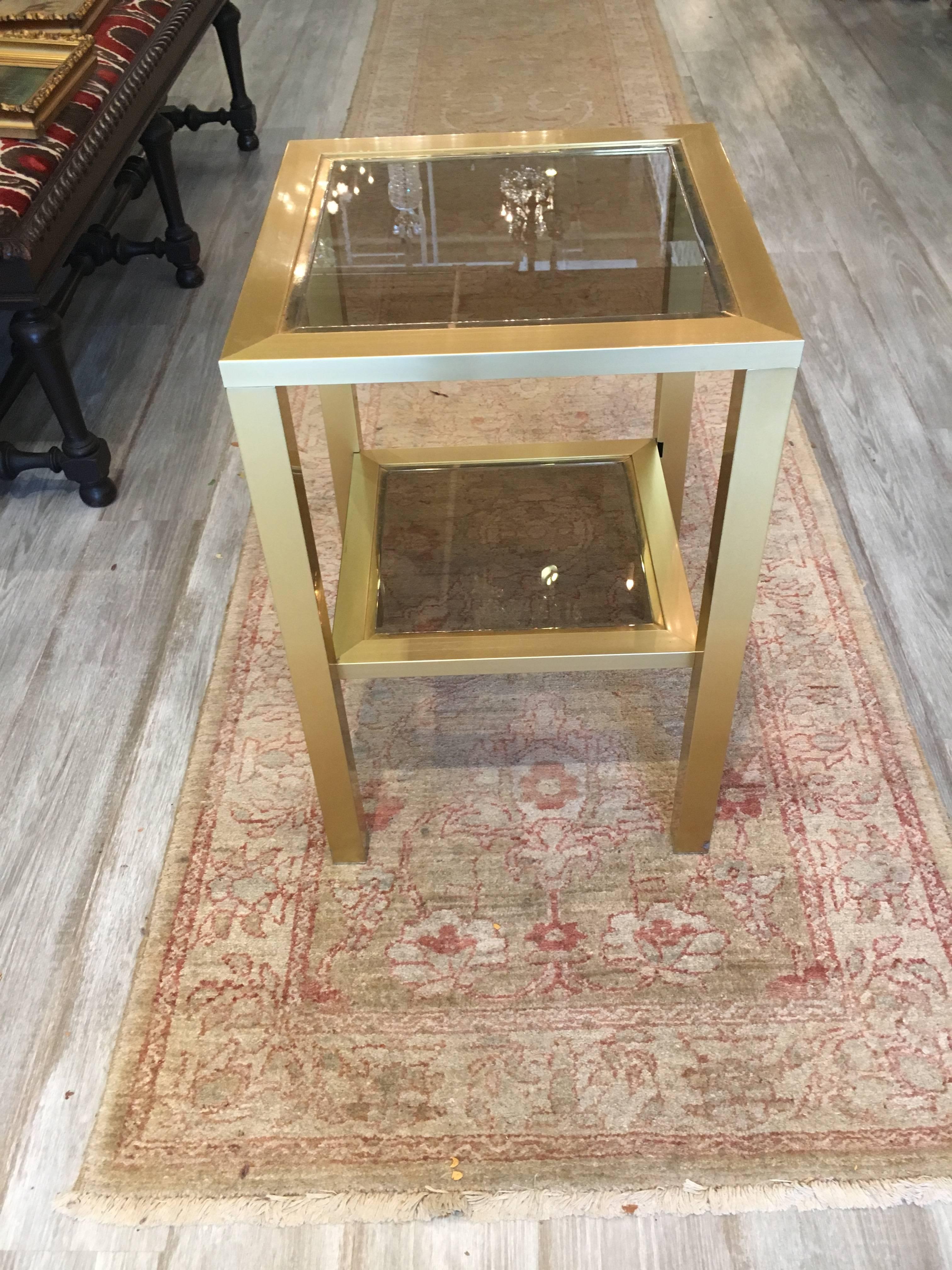 Fabulous pair of French side tables, perfect for drinks. Brushed brass and smoked inset glass, France, 1980s, excellent condition.
 
