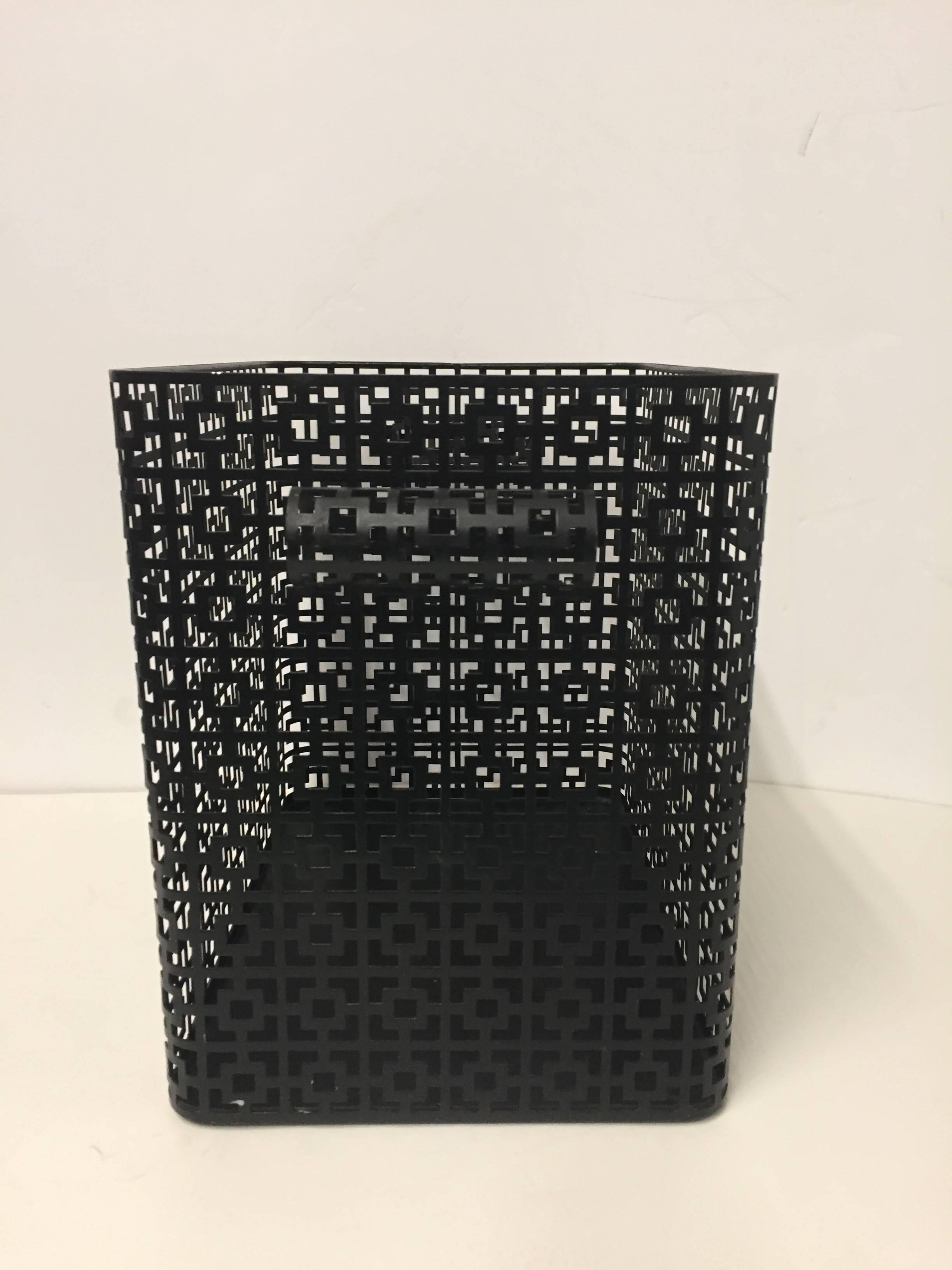 Handsome rectangular black steel wastepaper basket with a striking pierced geometric pattern.