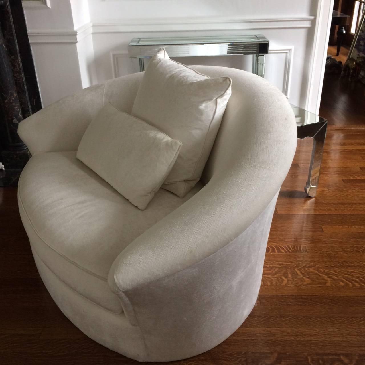 Two plush white velvet loveseats with a curvy sensual silhouette, glamorous from every angle.  Bun feet covered in the same fabric are included.