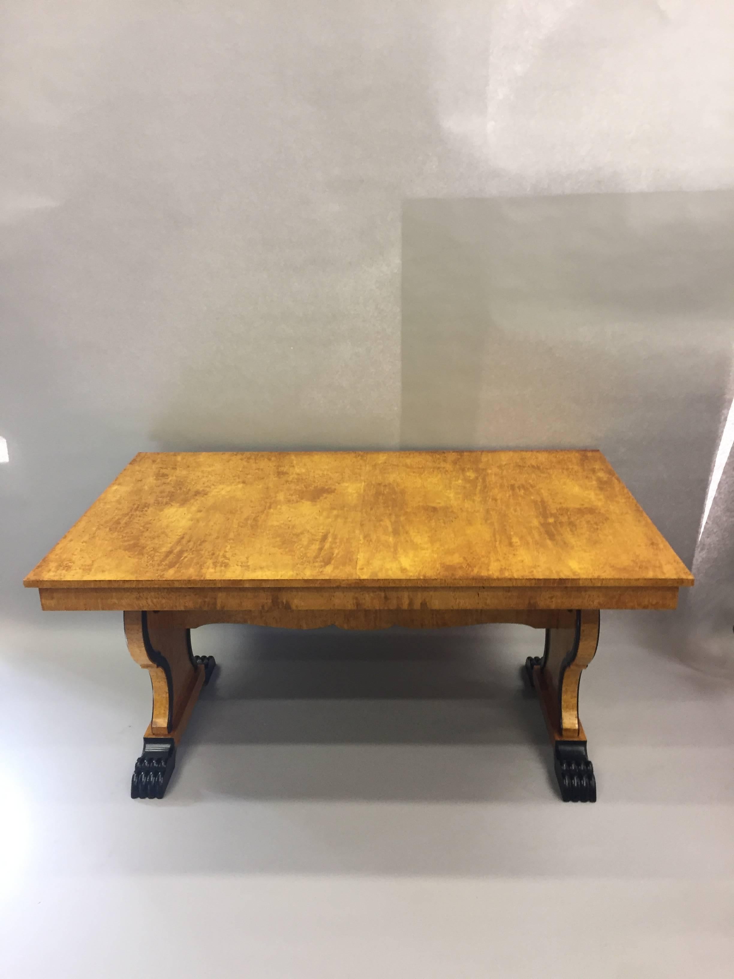 Magnificent Biedermeier dining table having ebonized carvings and banding that add a stunning contrast to the blonde polished bird's-eye maple veneer. Base appears to be ash. Opens with two extension leaves to an impressive 107.25 L.
Measures: Each