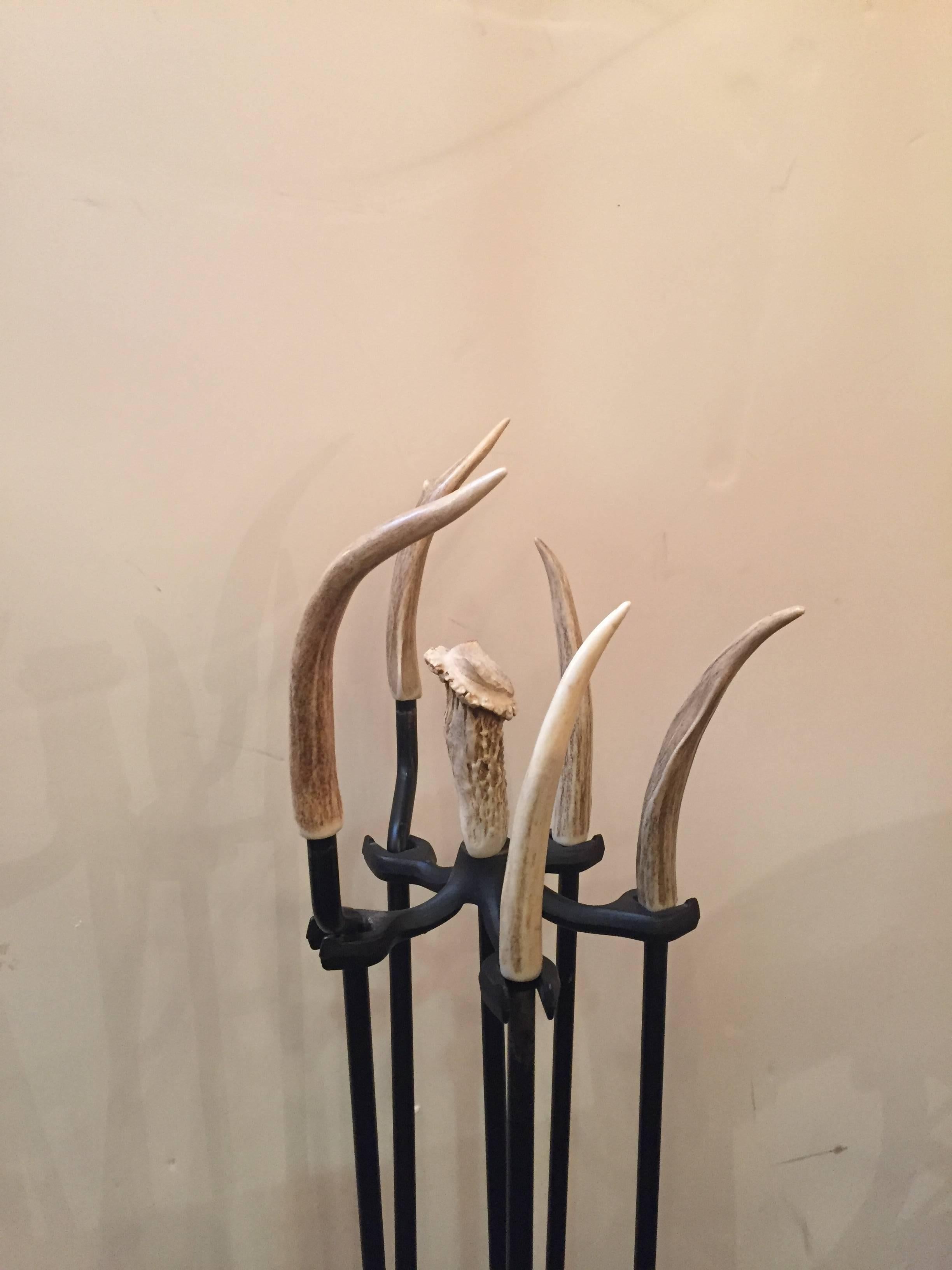 Fabulous iron fireplace tools with real antler handles and base. Includes four tools: Broom, shovel, poker and log turner.