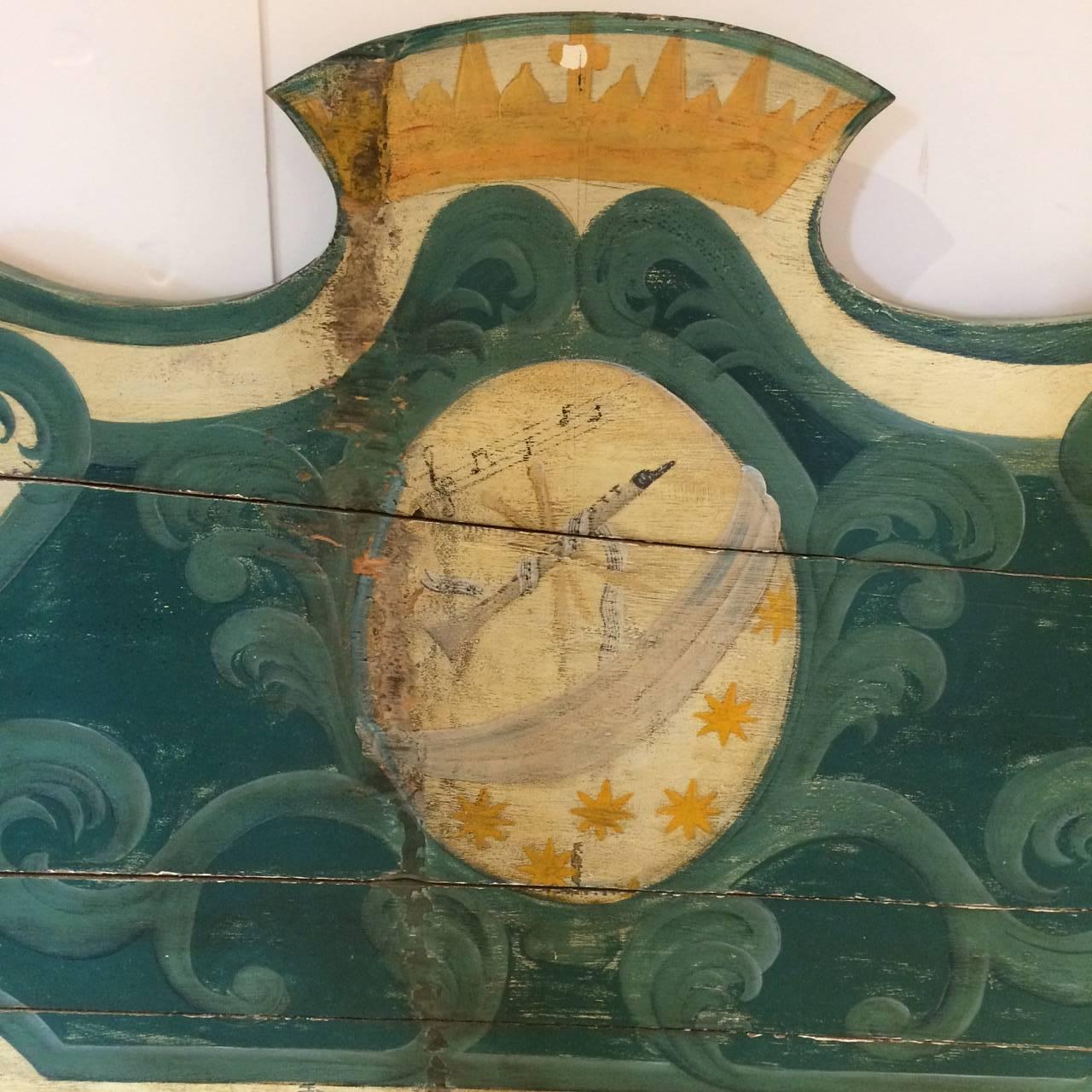 Wonderful large distressed wood bench having a scalloped back and seat that opens to reveal storage within, all hand-painted with charming curlicues and a French musical horn and musical notes in a central mandala, with a soft color palette of cream
