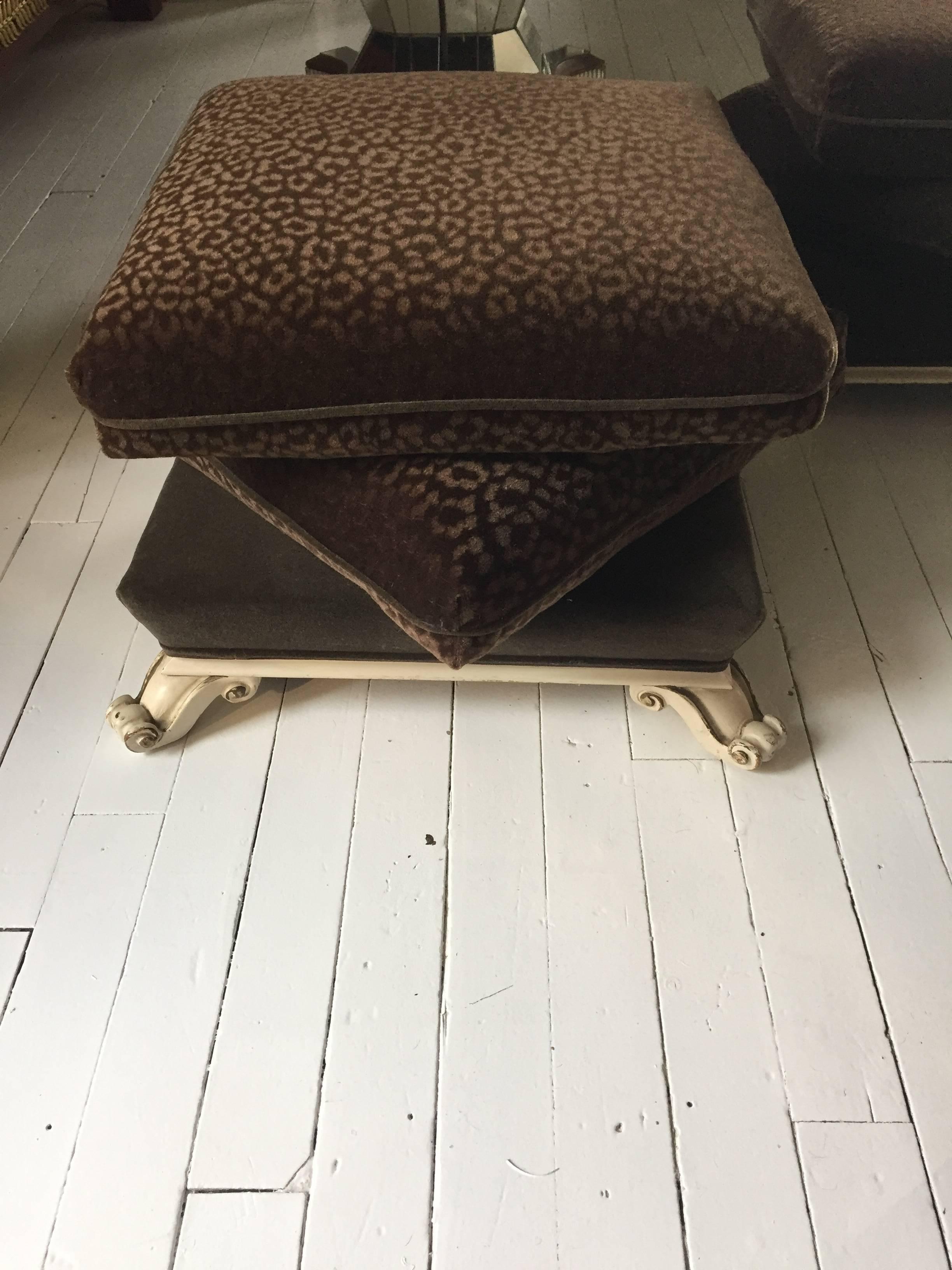 Two super plush brown on brown faux animal print mohair upholstered Rococo poufs, having three layers of sumptuous attached cushions, sitting on creamy Italianate carved wooden feet with gilt highlights.