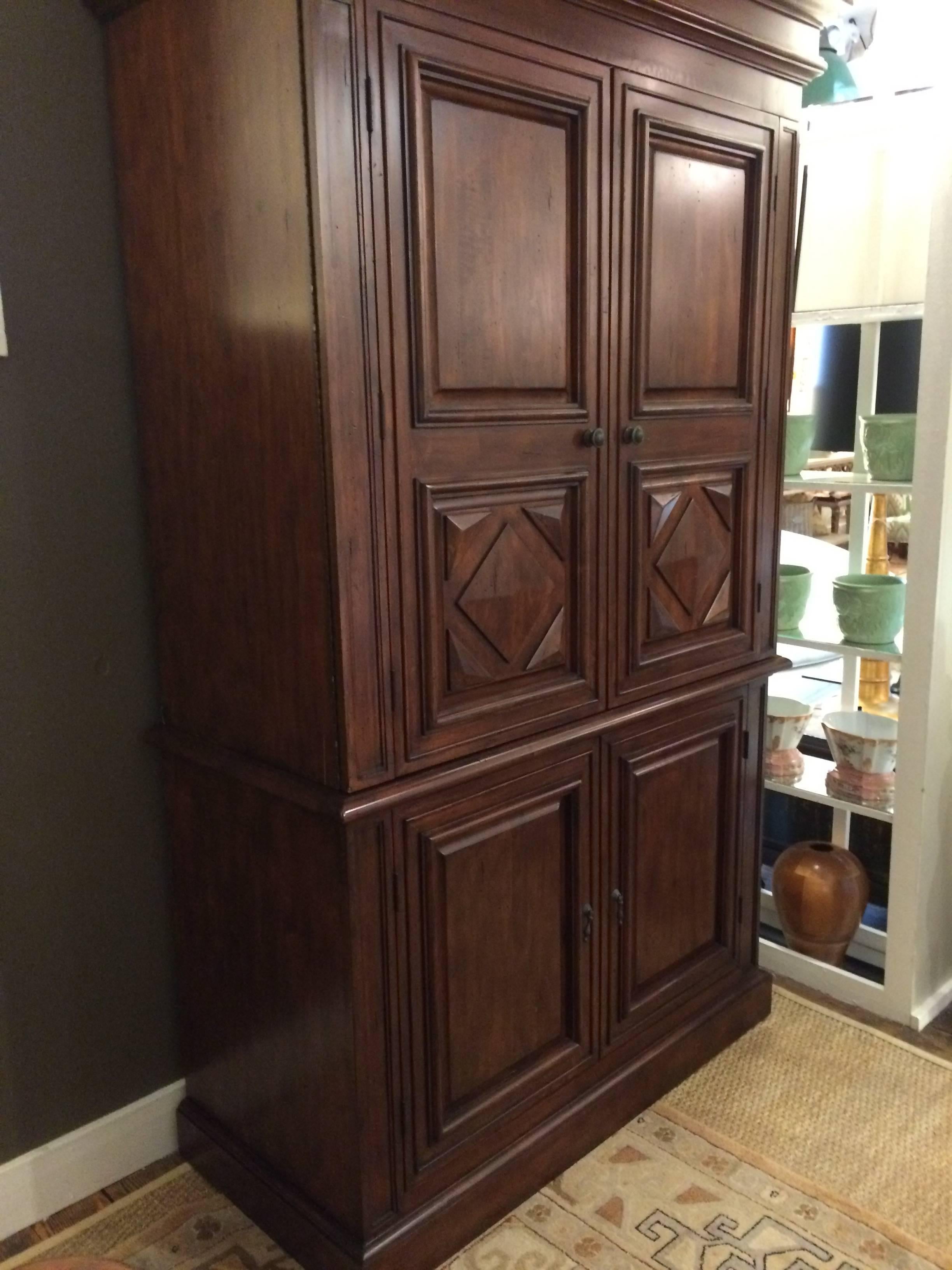 Rich looking wooden entertainment cabinet or armoire with multiple functions. The interior back is open if desired for television, but can be closed up as the removed panel is included.
There are brackets for a dowel if using the top for hanging