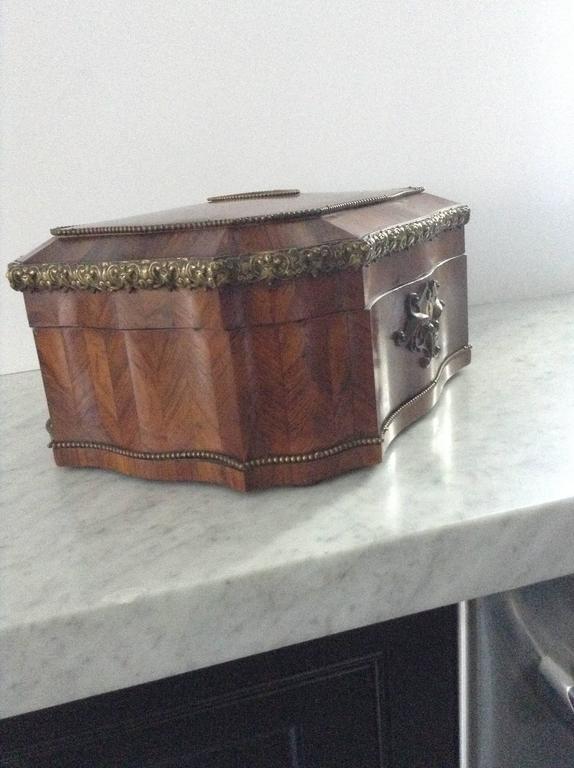 Gem of an antique French marquetry jewelry box with mirrored medallion on top. Brass beading adorns all edges of the box. Patina and grain of wood are superb. Excellent condition on exterior. Interior needs relining, if desired.
 