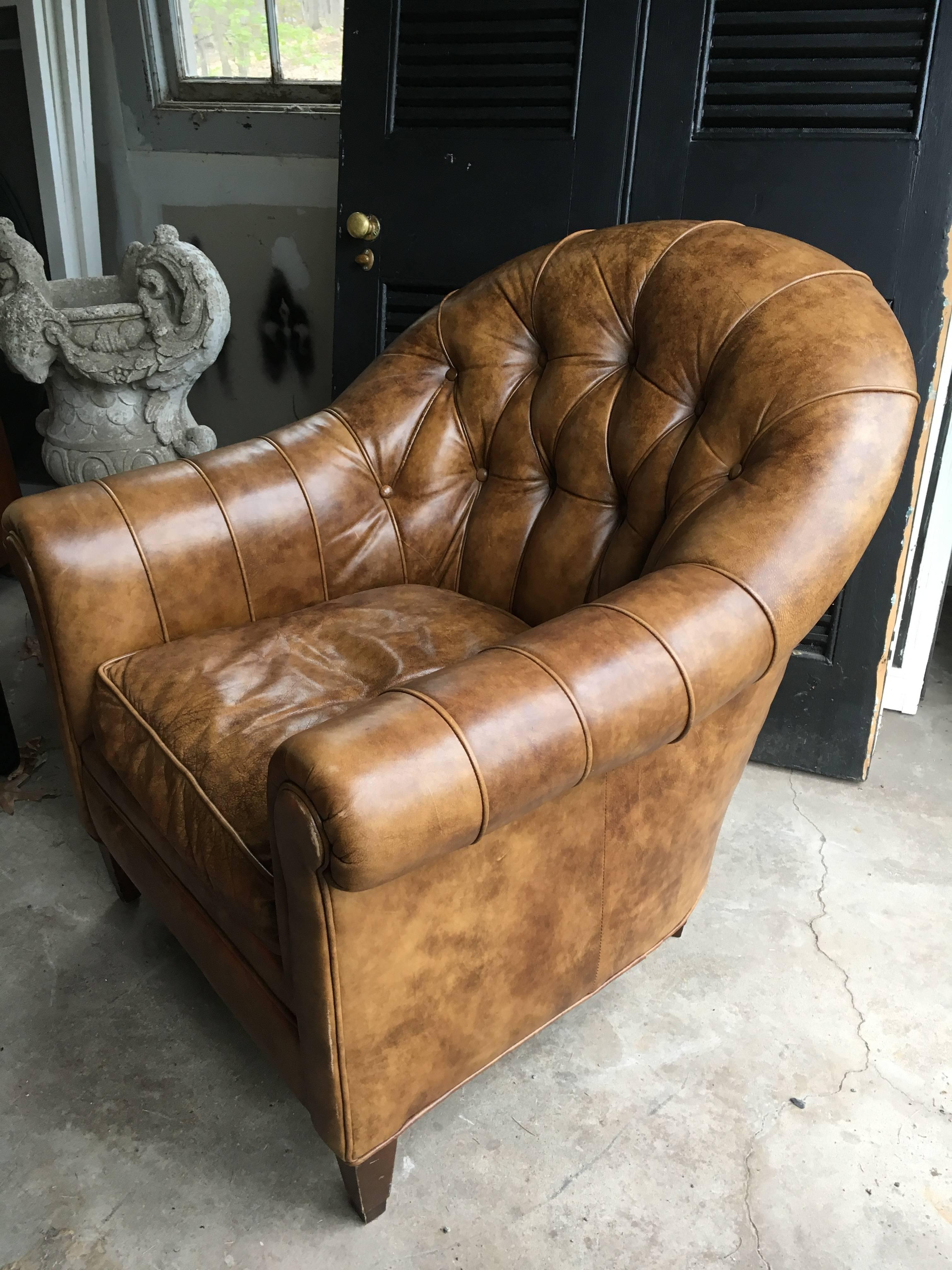 Sophisticated and handsome leather club chair in a wonderful shade of camel with brown undertones. Tufted back and one loose cushion. Tags under cushion. Seat height is 18