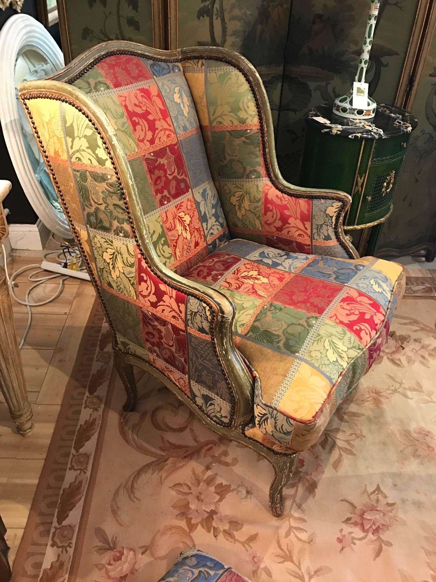 Fabulous comfy winged shepherdess, also known as a confessional armchair, is a resting seat with a deep cushion of feathers, while her ears are made for resting the head. Wonderful distressed green painted frame and checkerboard jacquard upholstery.