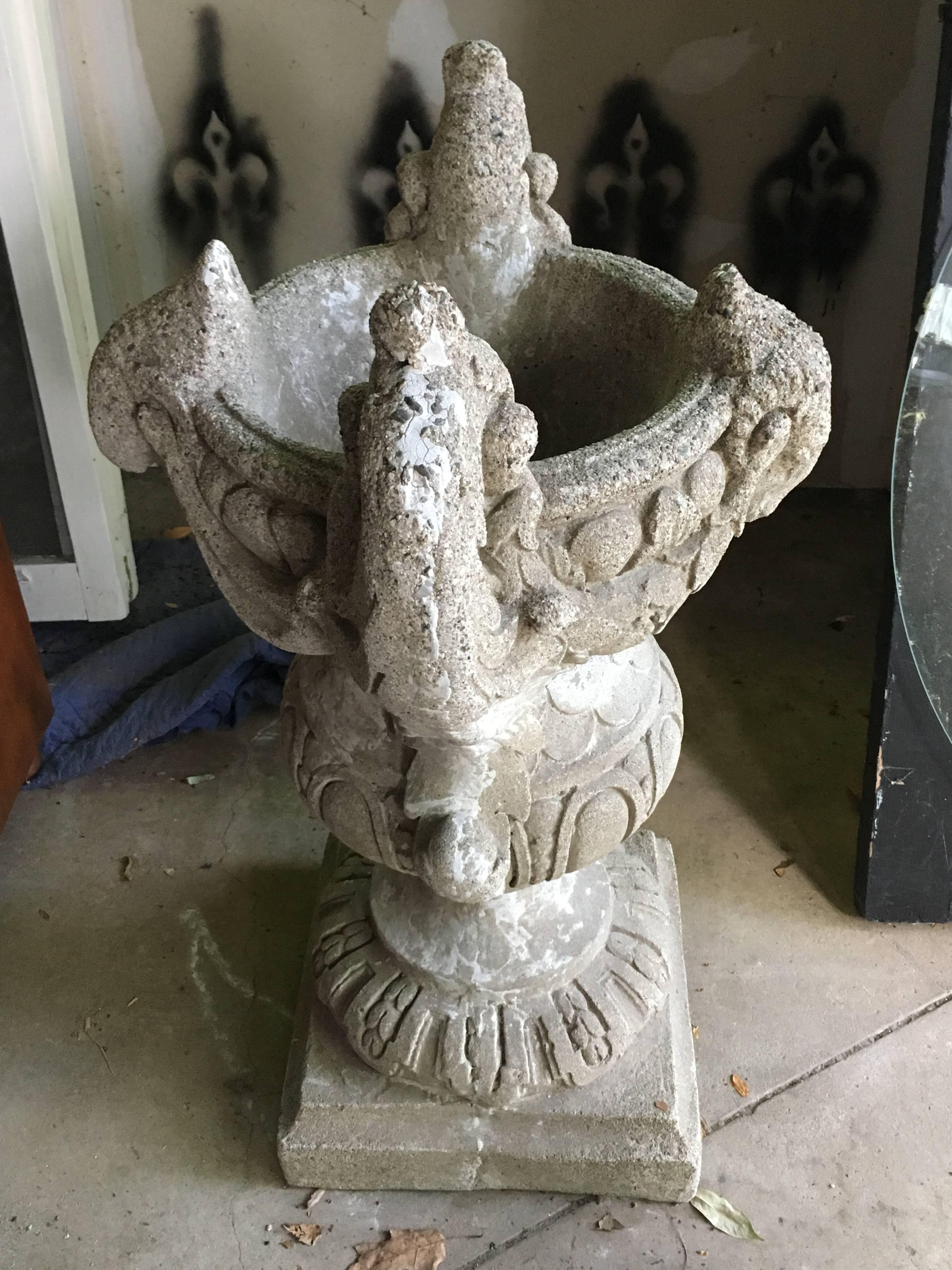 Stately one-of-kind concrete garden urn from the 1920s. Decorative handles have swags of leaves that terminate in ram's heads on each side. Base is 14