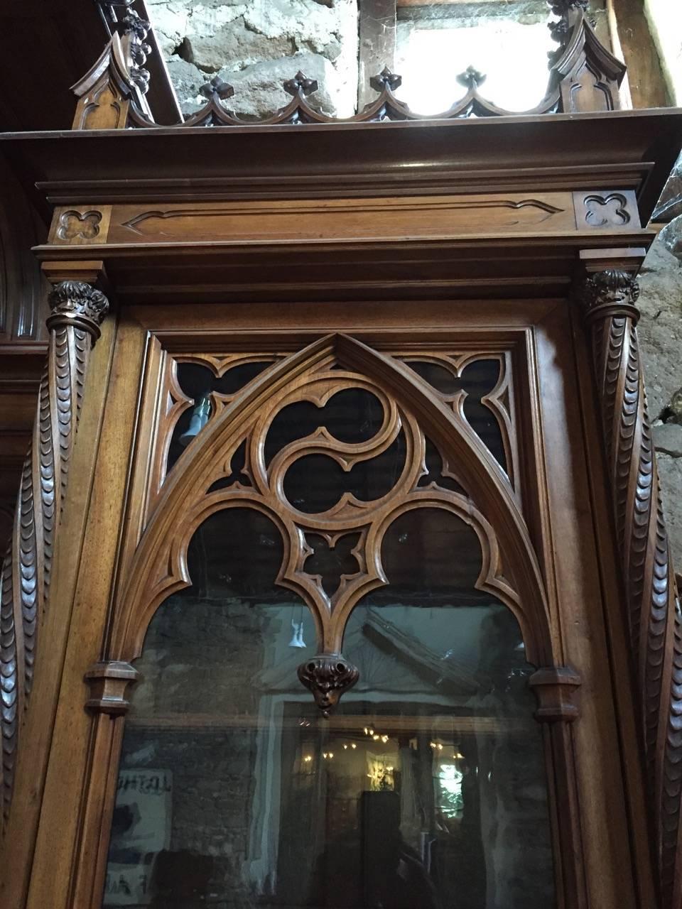 Fabulously carved French Gothic Revival mahogany bookcase signed “A. Bastel, Lyon”.