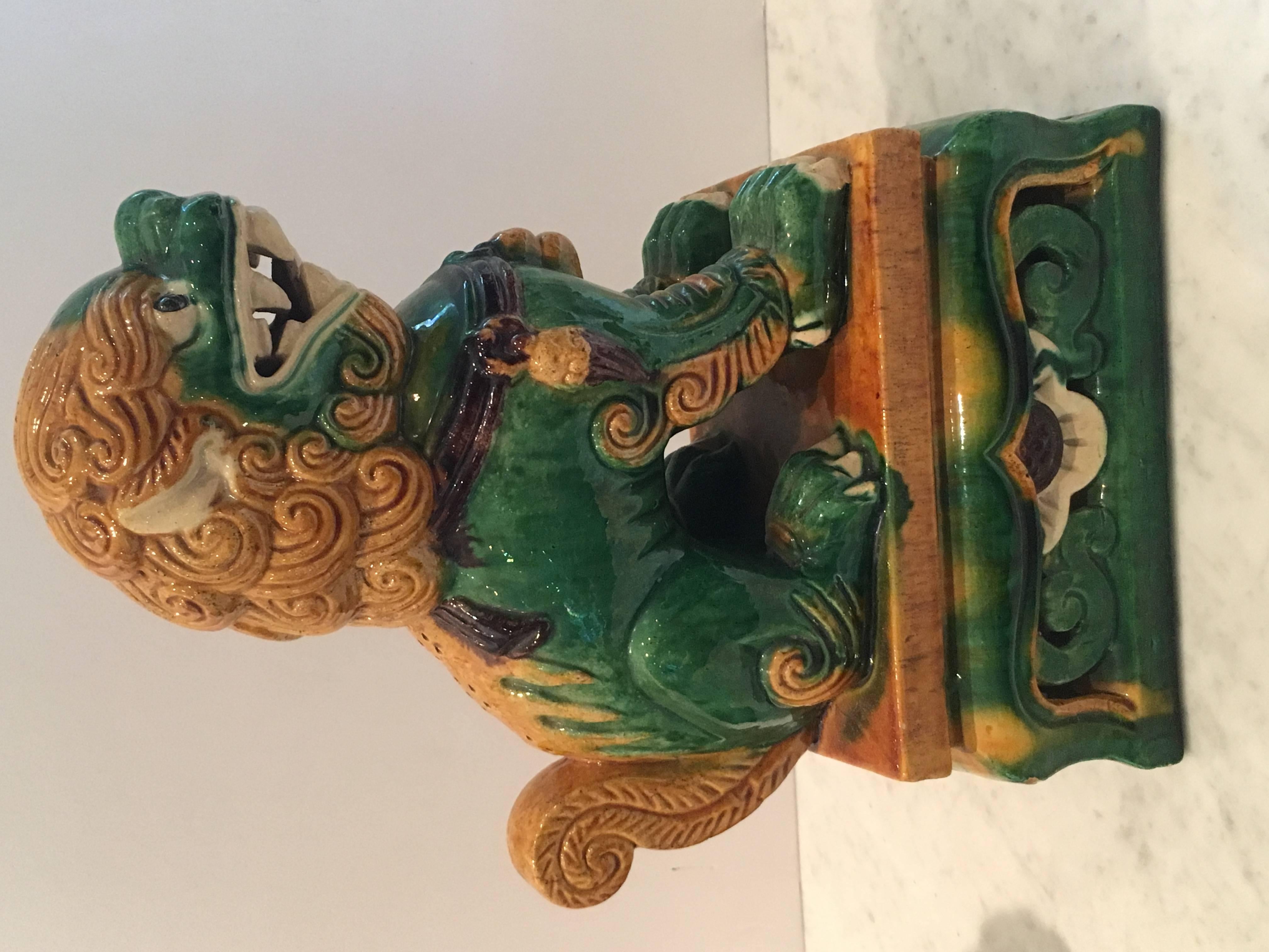 Colorful Pair of Mid-Century Chinese glazed porcelain foo dogs. Almost identical, the male has more green glaze on face, whereas the female has more green glaze on feet and base. Wonderful attention to detail.