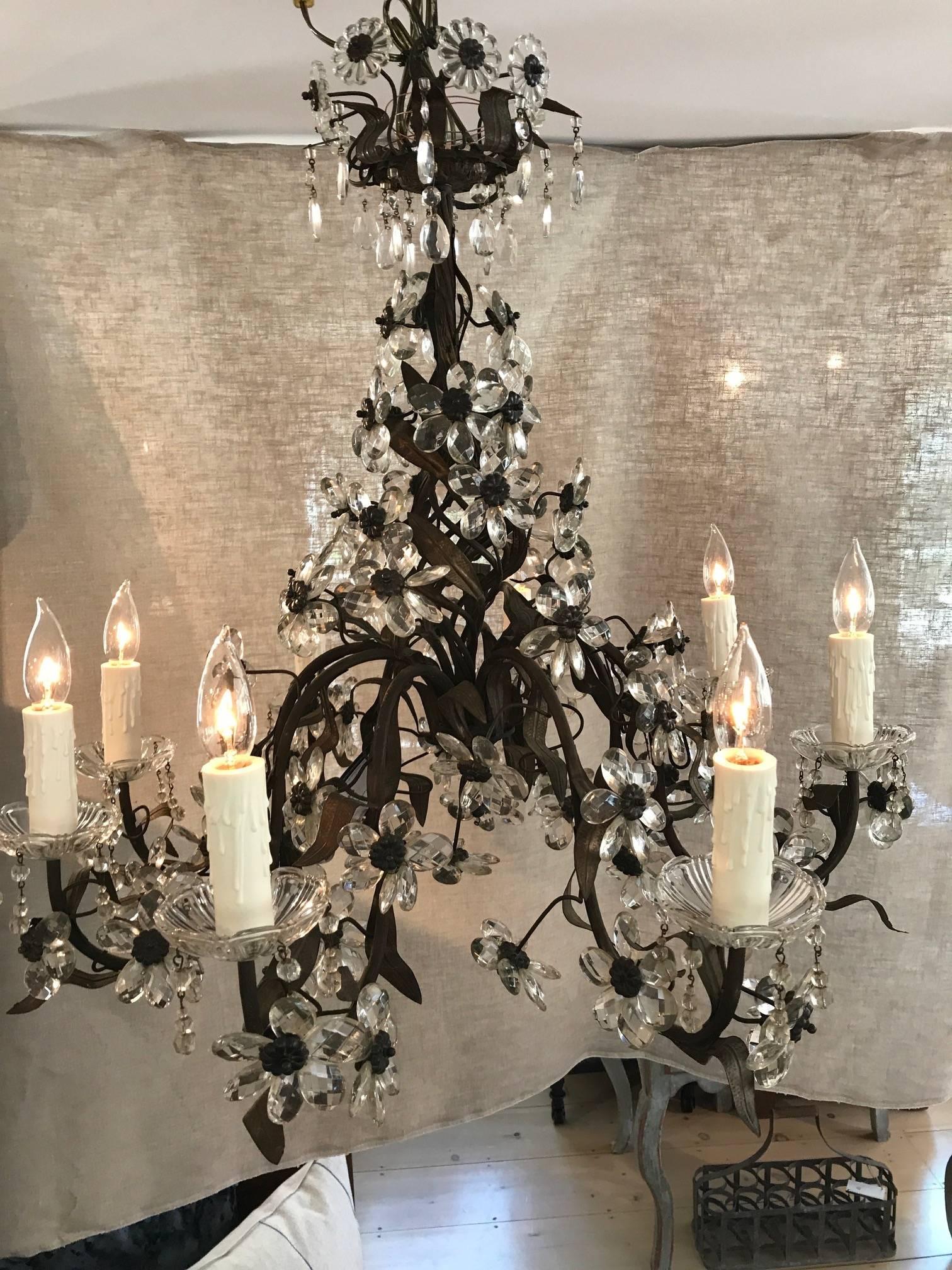 Beautiful crystal eight-light French floral chandelier with smooth cut crystal flowers and brass leaves and accents. The condition is very good, and it is newly rewired. Drop height can be adjusted. It was bought in Montpellier, France.

Measure: