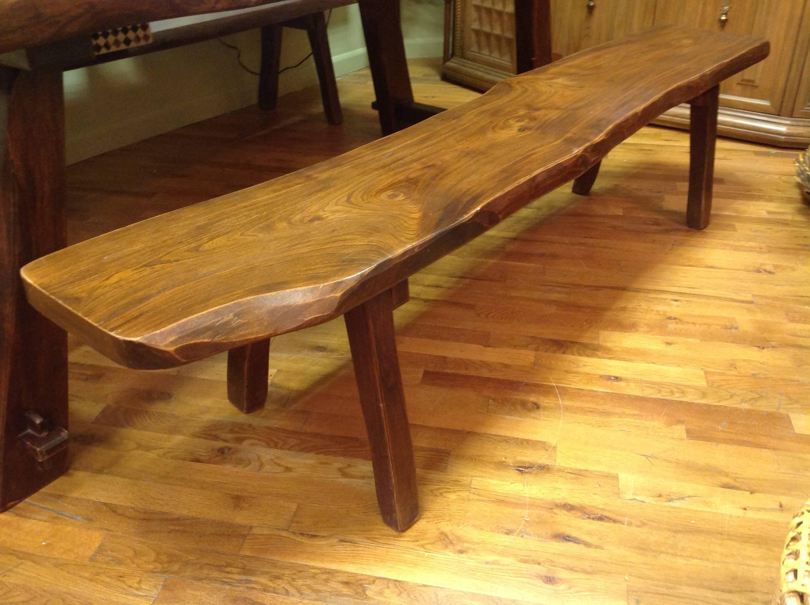 Organic pair of live-edge slab-top benches made in France by a local artisan. Hand-hewn from natural, solid hardwood, these benches work well in both contemporary and traditional interiors or on either side of a farm table. Slabs are 2
