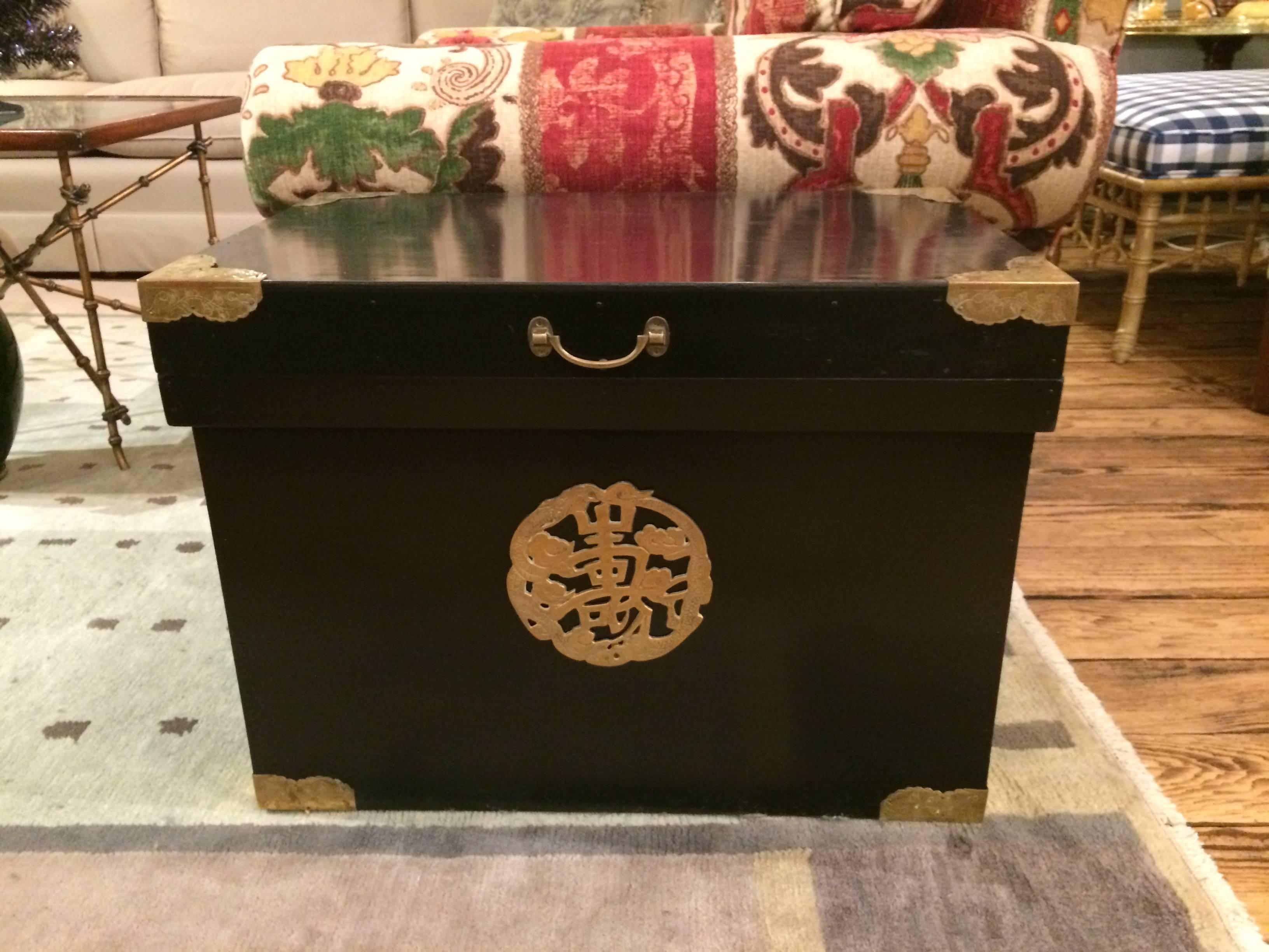 Black ebonized tea trunk with stunning brass corners and Asian embellishment on the front. Lined in galvanized tin.
Makes a stunning and surprising end table.