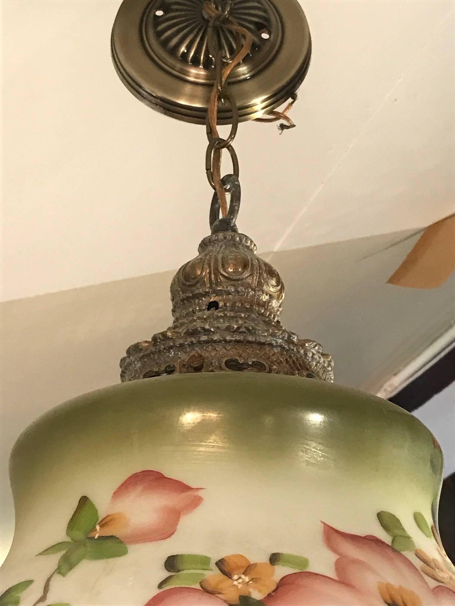 Very pretty hand-painted glass pendant light fixture having ornate brass elements on both top and bottom.