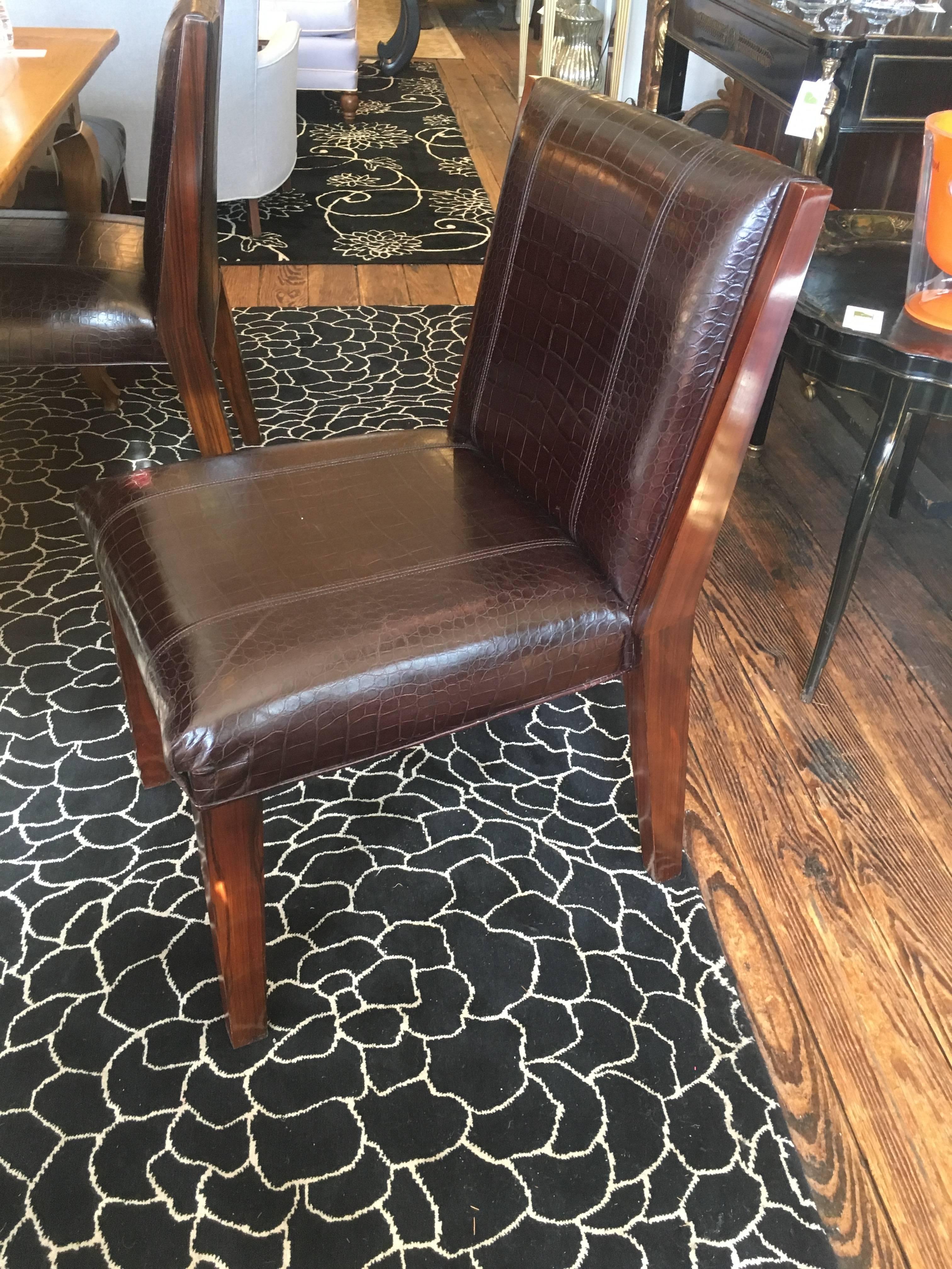 Very handsome traditional Ralph Lauren Modern Metropolis side dining chairs in a dark leather embossed with a crocodile pattern and sturdy dark wood legs (we think Rosewood) Designer label on underside of chairs. Originally $2000/chair
have