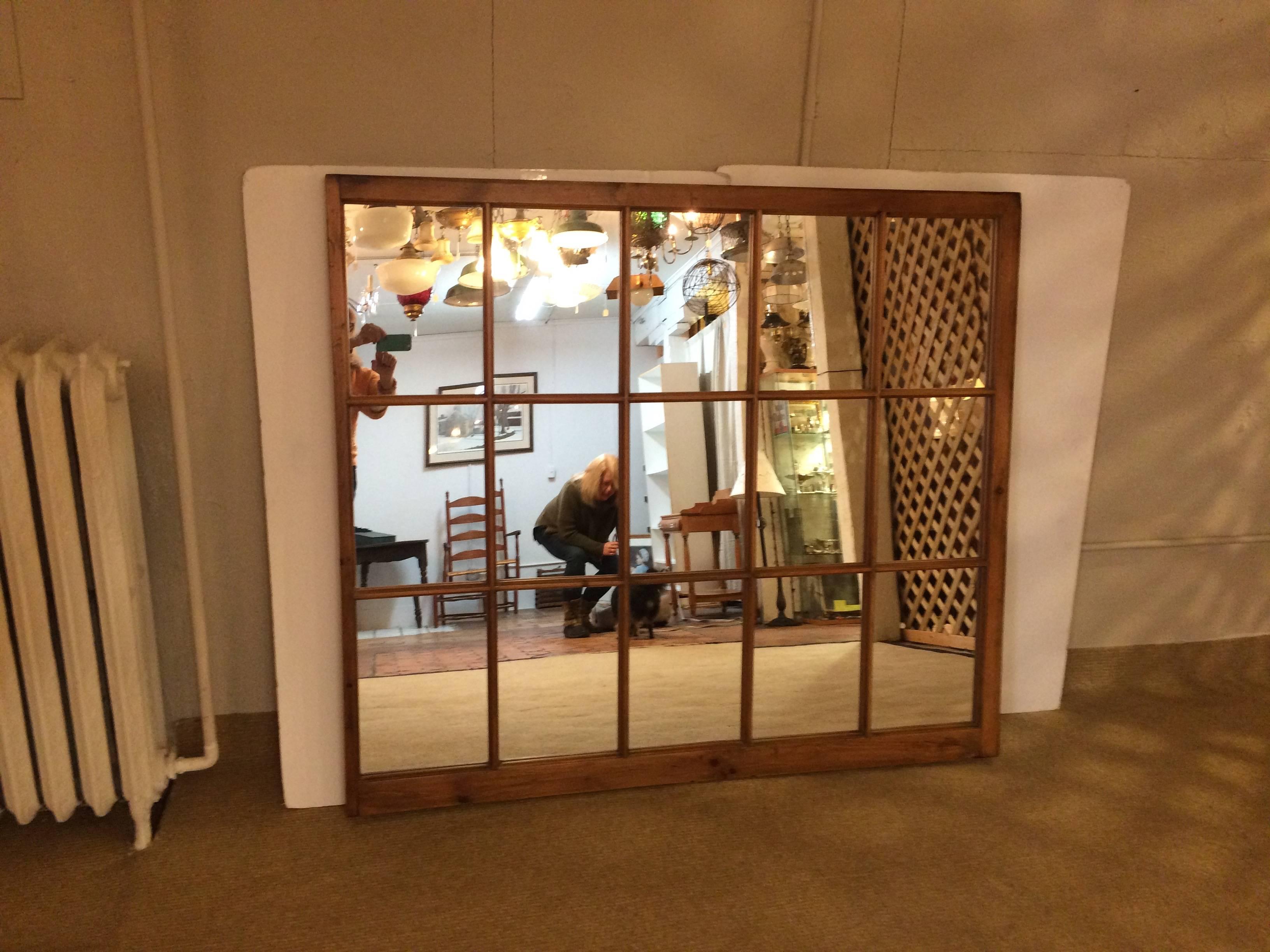 Handsome very large antique pine window that's been transformed into a striking architectural mirror. Can be hung vertically or horizontally.