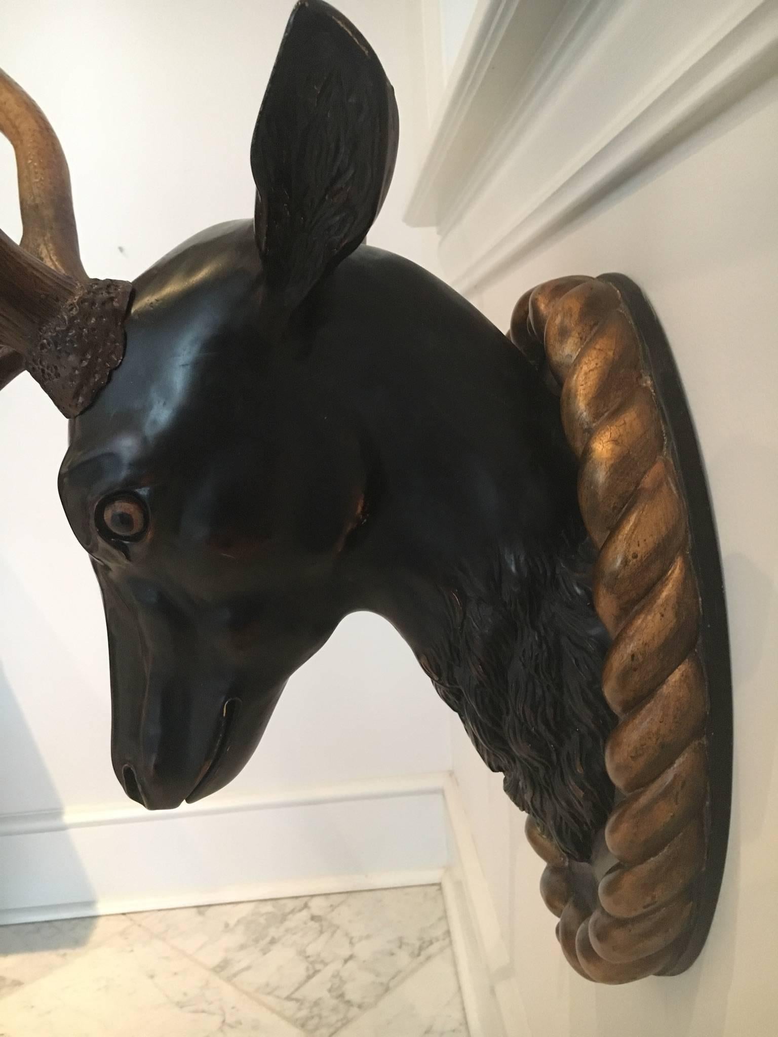 Absolutely stunning stag with large antlers and a gilt roping surround. Perfect for a den or library, this sculpture is comprised of wood, metal and composite.